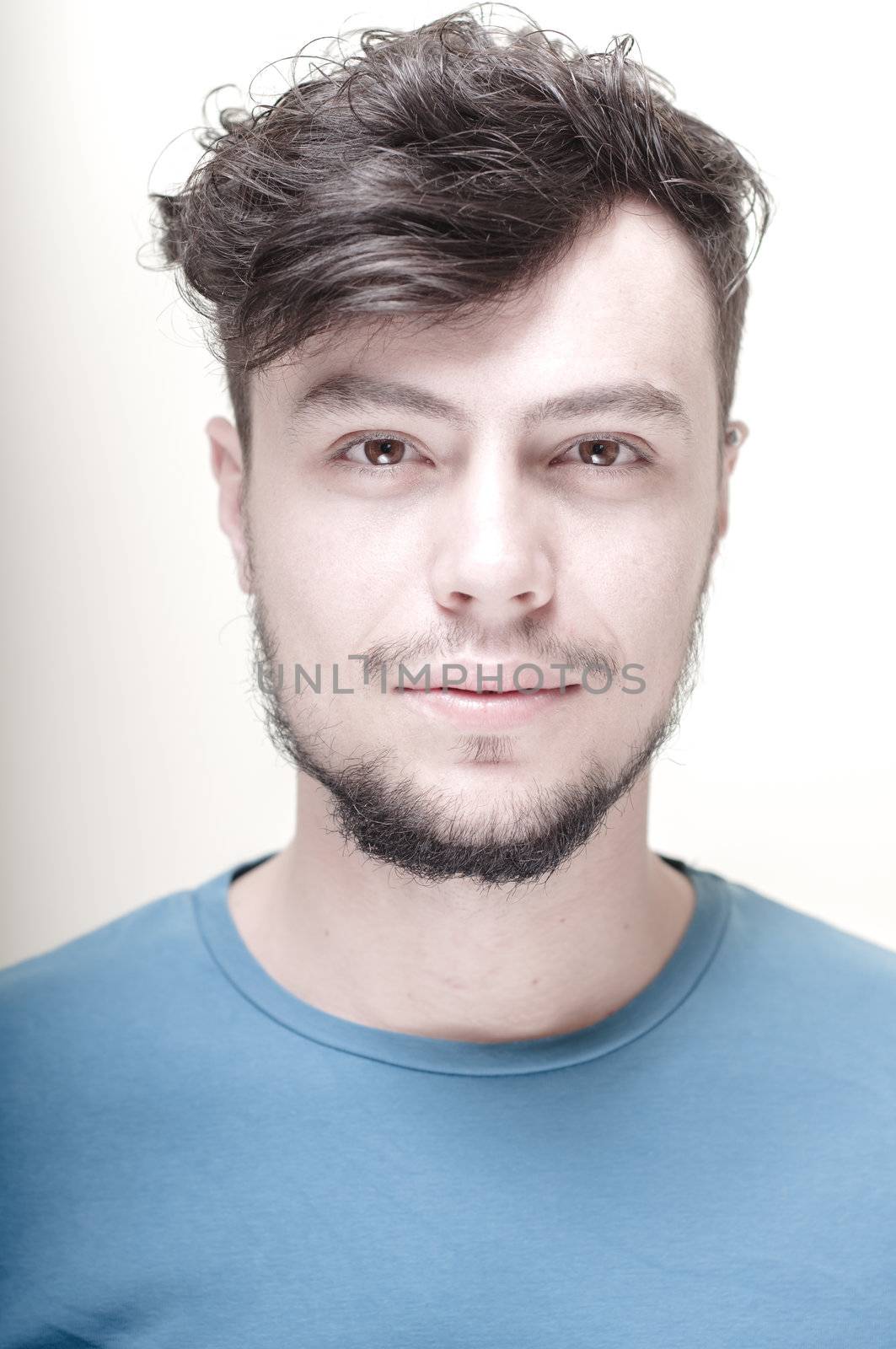 portrait of stylish young man with blue shirt on vignetting background