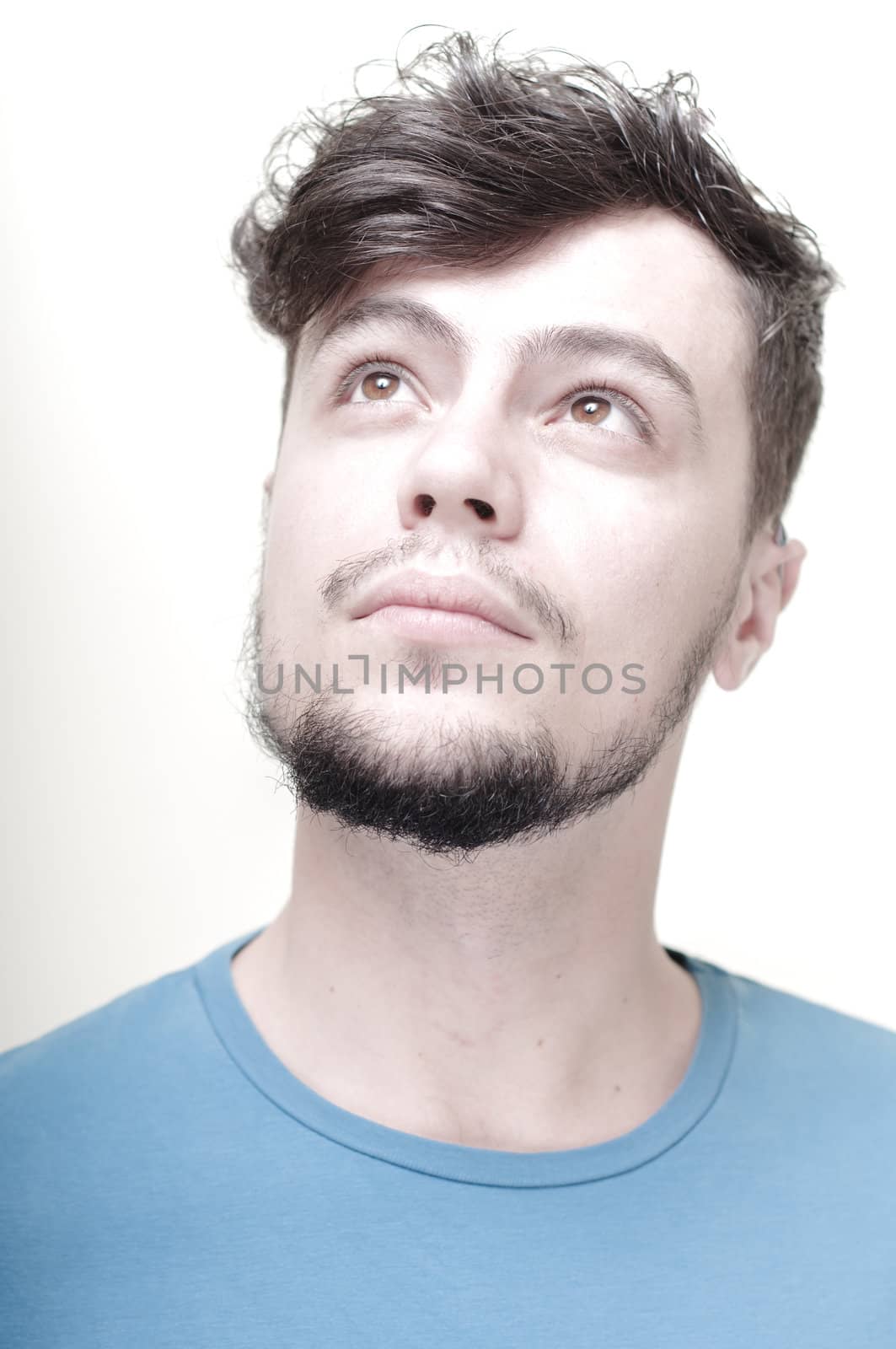 portrait of stylish young man with blue shirt on vignetting background