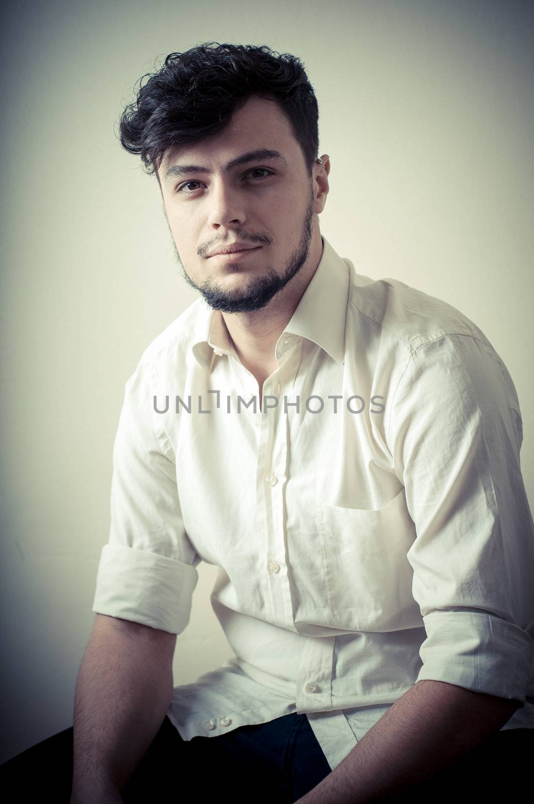young modern stylish man on vignetting background