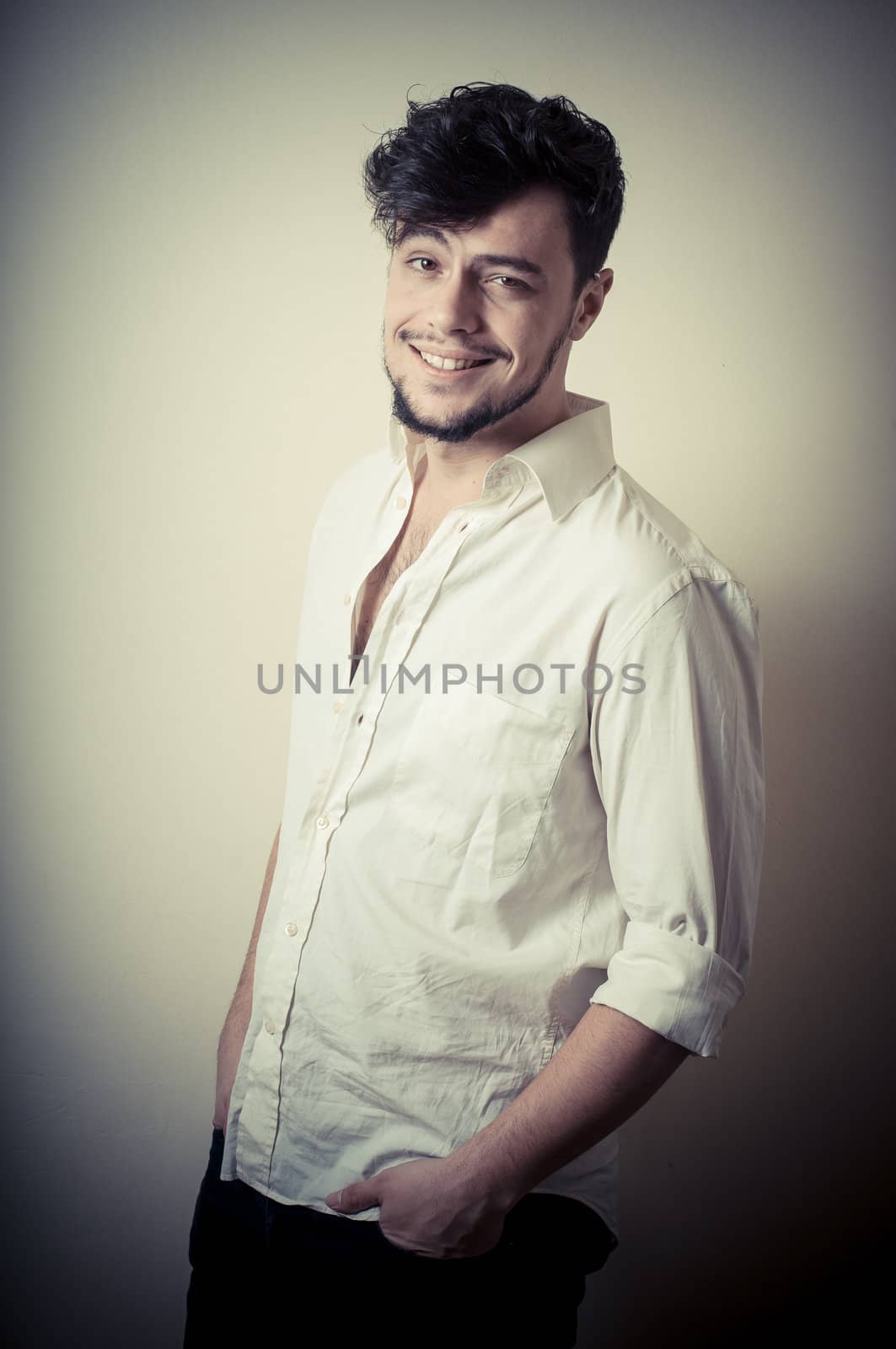 young modern stylish man on vignetting background