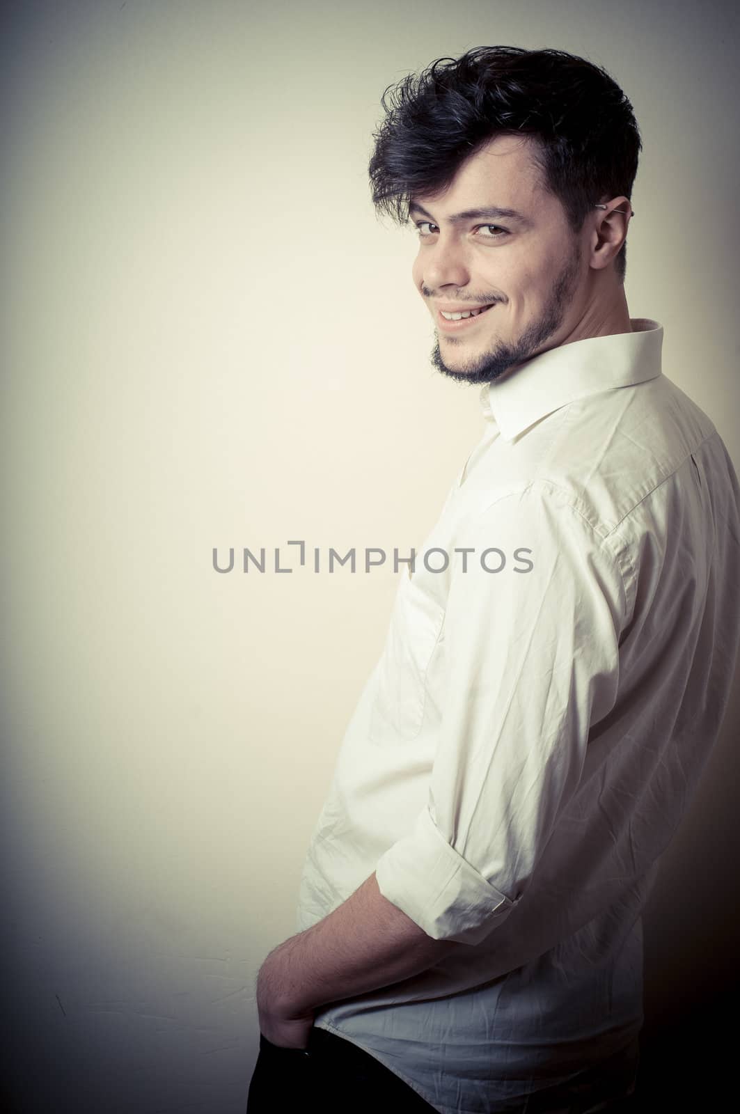 young modern stylish man on vignetting background