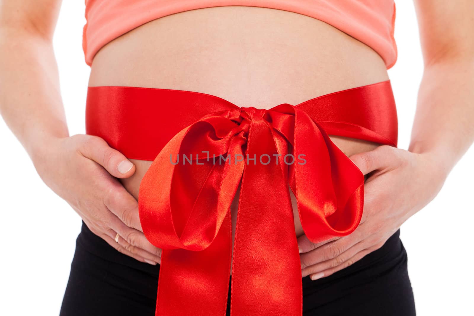 Beautiful pregnant belly with bow on a white background