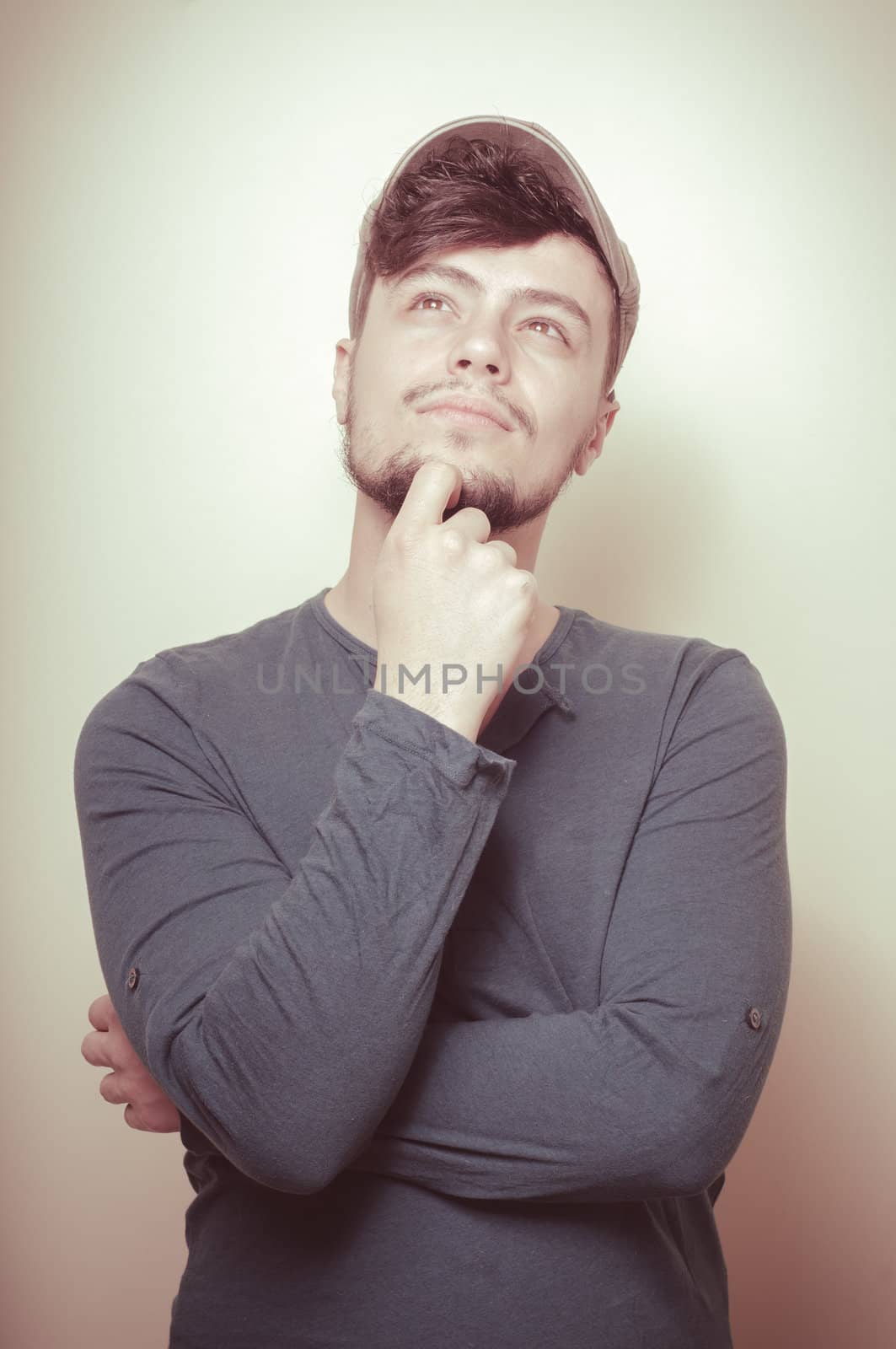 young modern stylish man with cap on vignetting background