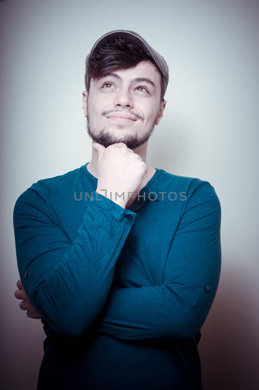 young modern stylish man with cap on vignetting background