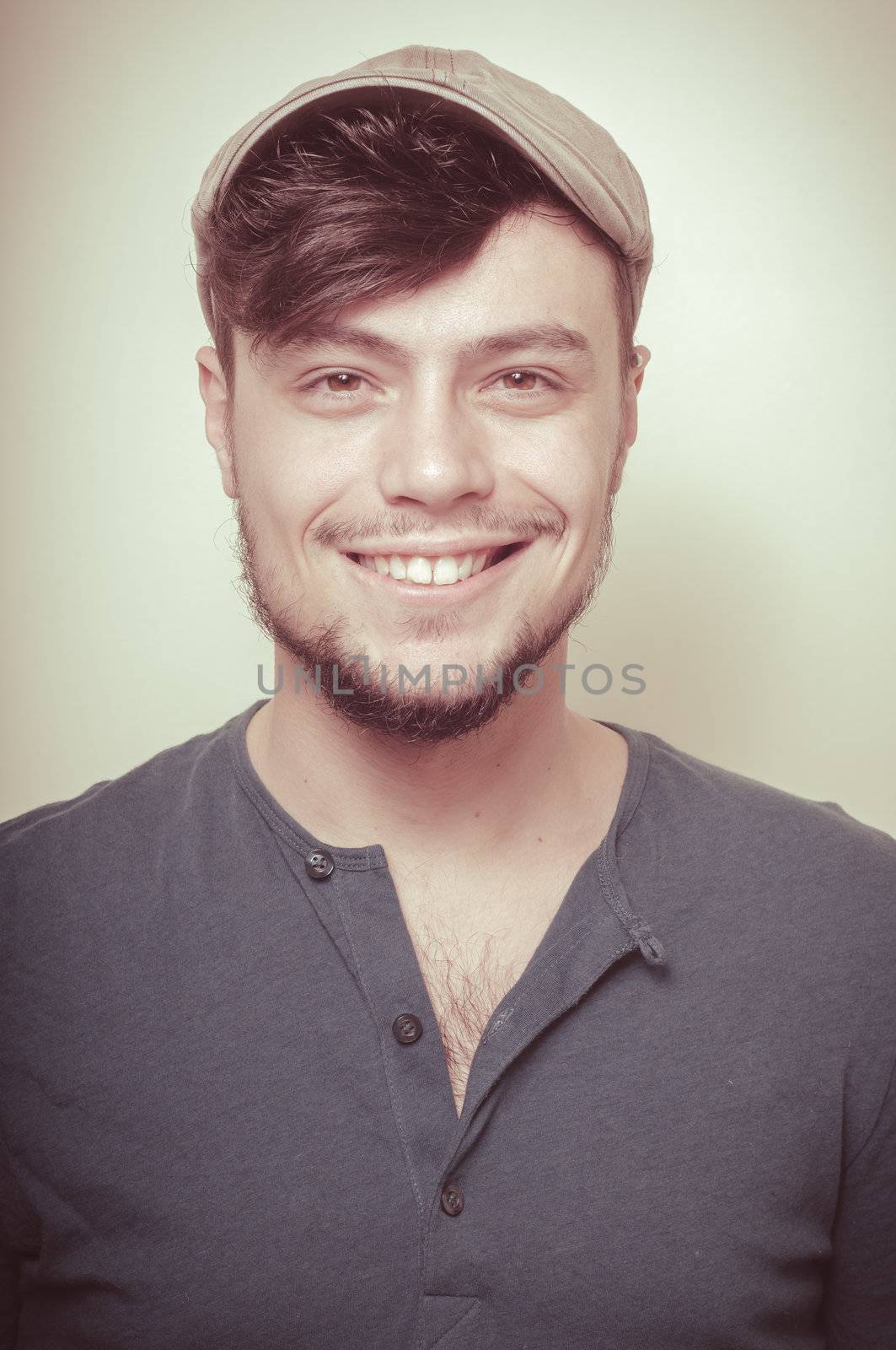 young modern stylish man with cap on vignetting background