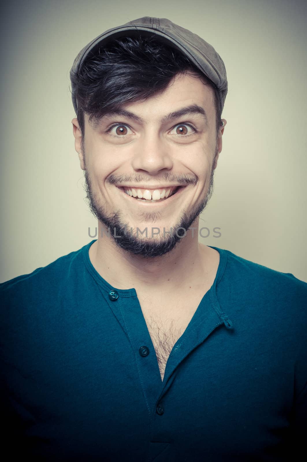 young modern stylish man with cap on vignetting background
