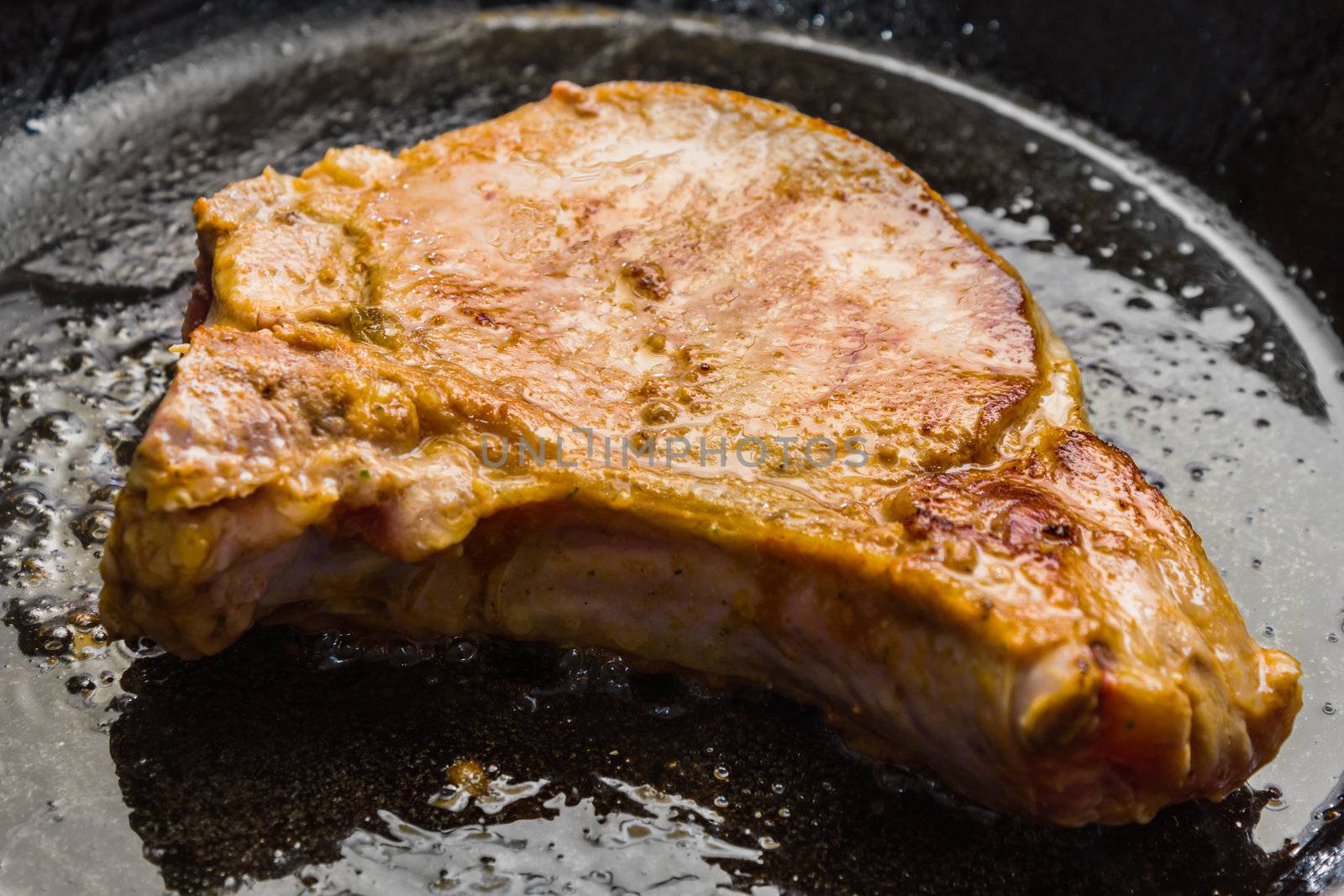Roasted pork steak in a frying pan