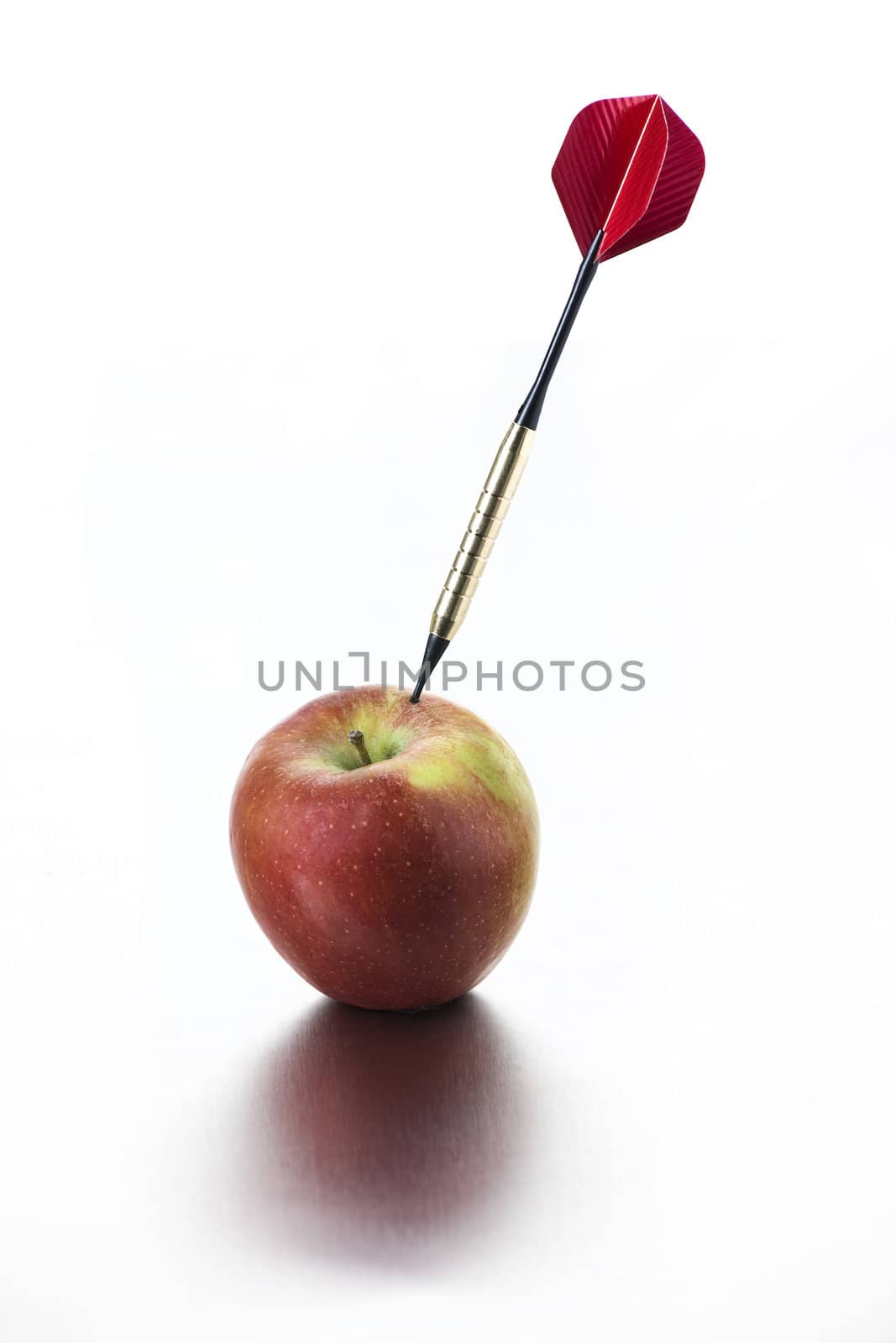 Red apple with dart on white