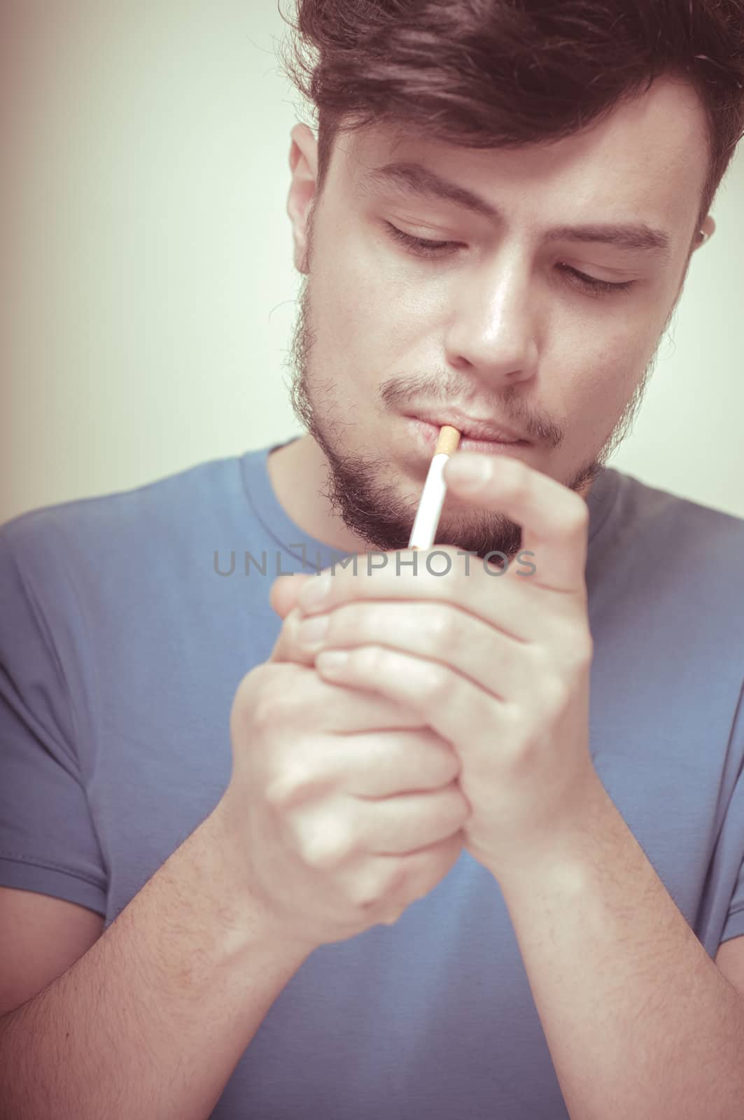 stylish young modern man with cigarette on vignetting background