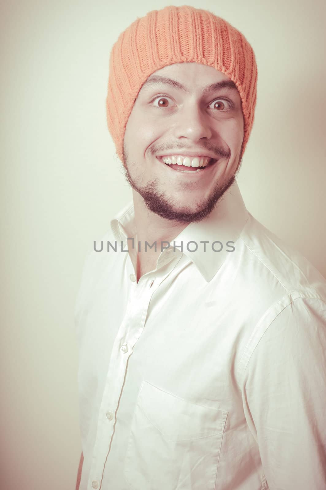 young modern stylish man with orange cap on vignetting background