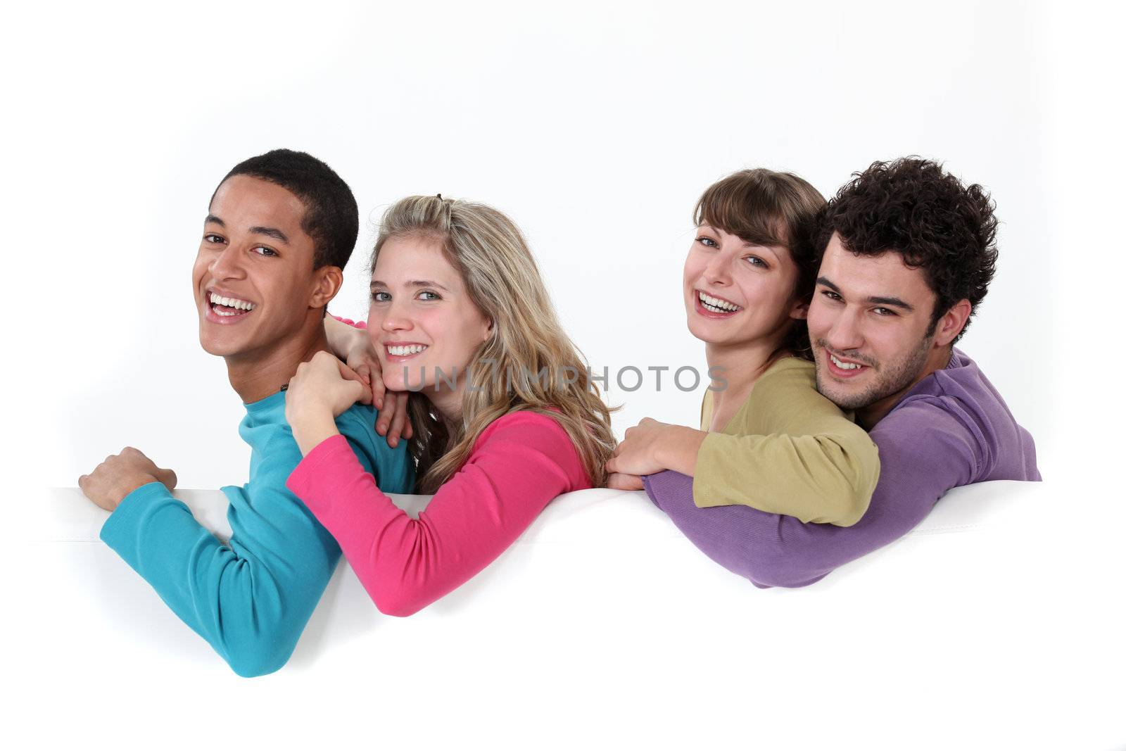 Two couples stood with blank poster by phovoir