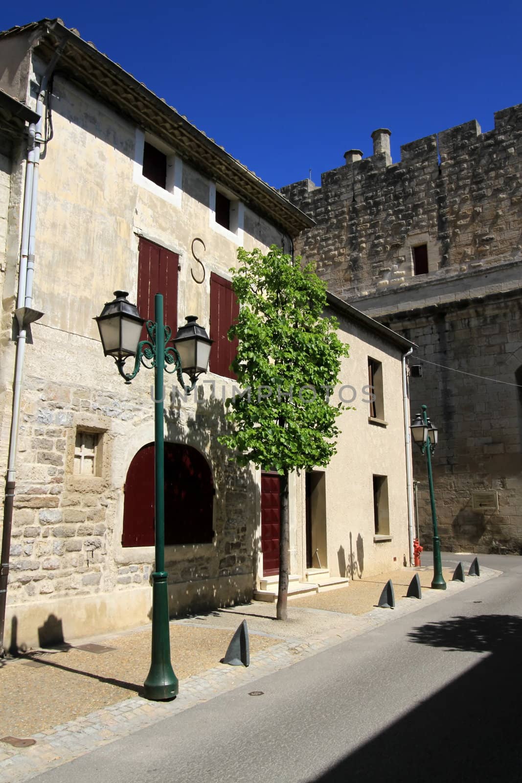 Old house, streetlamp and battlements by beautiful weather in Aigues-Mortes, Camargue, France