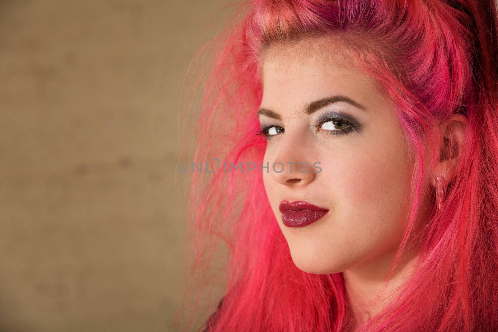 Conceited teenage female with pink hair close up