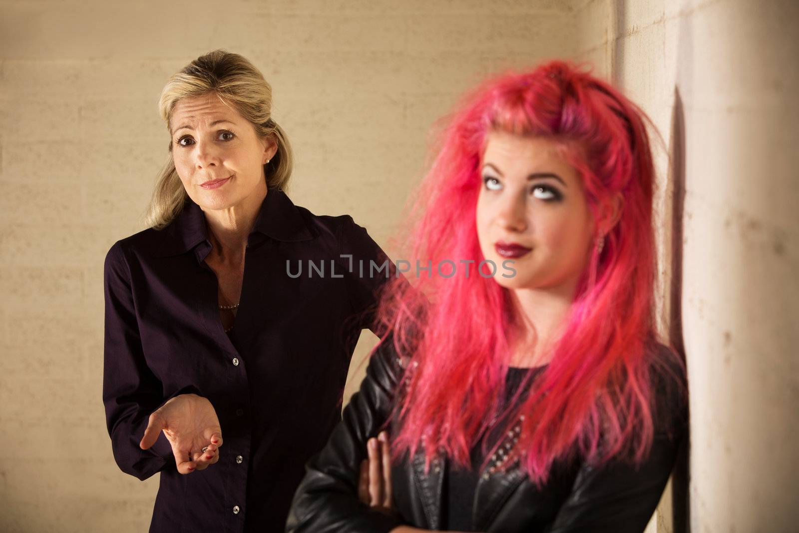 Indifferent European mother with daughter in pink hair