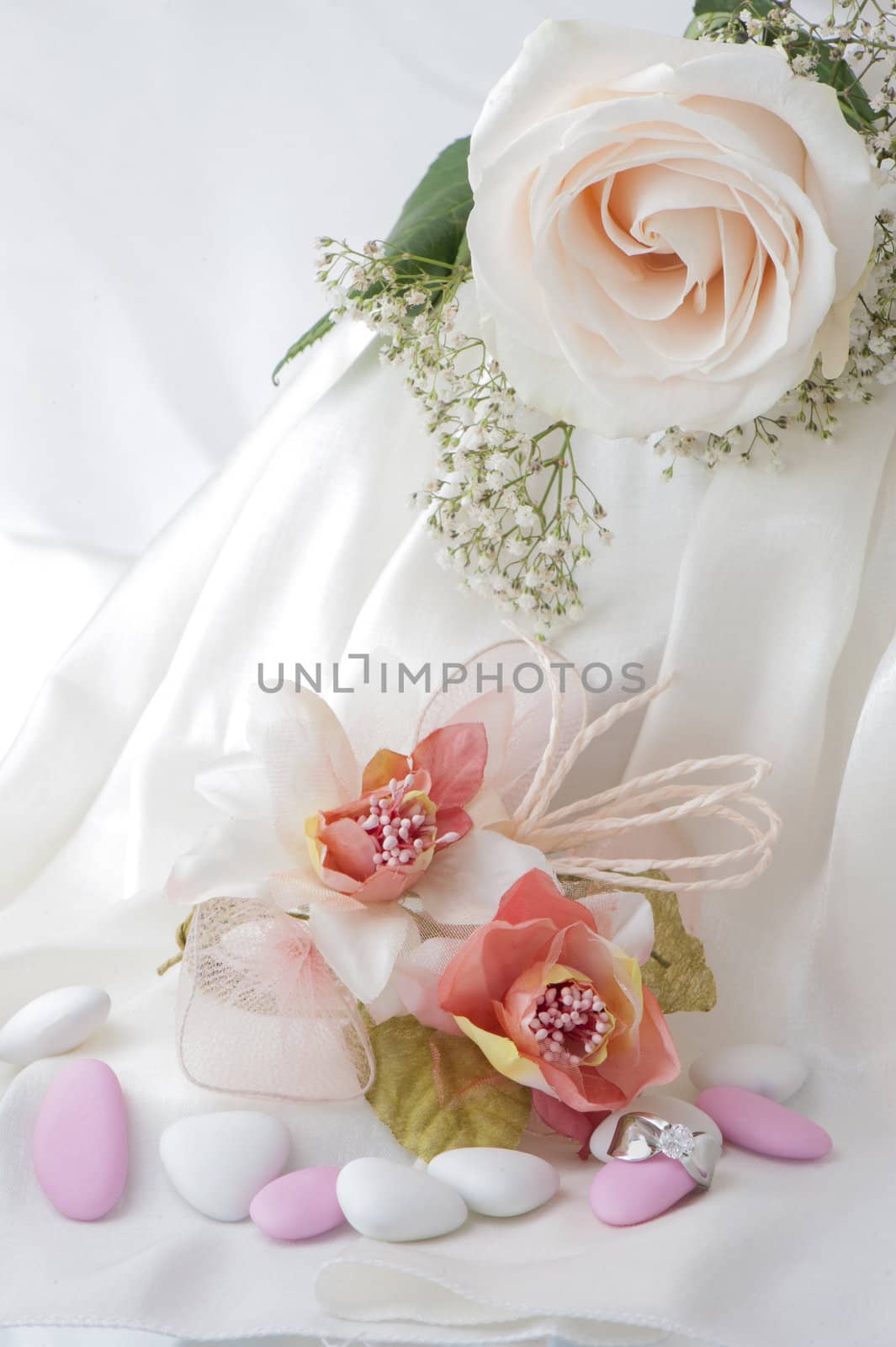 Wedding favors,wedding rings and flowers on white background