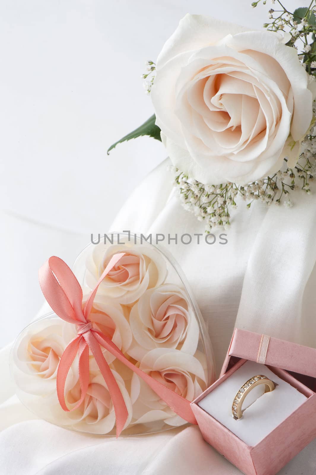 Wedding favors,wedding rings and flowers on white background