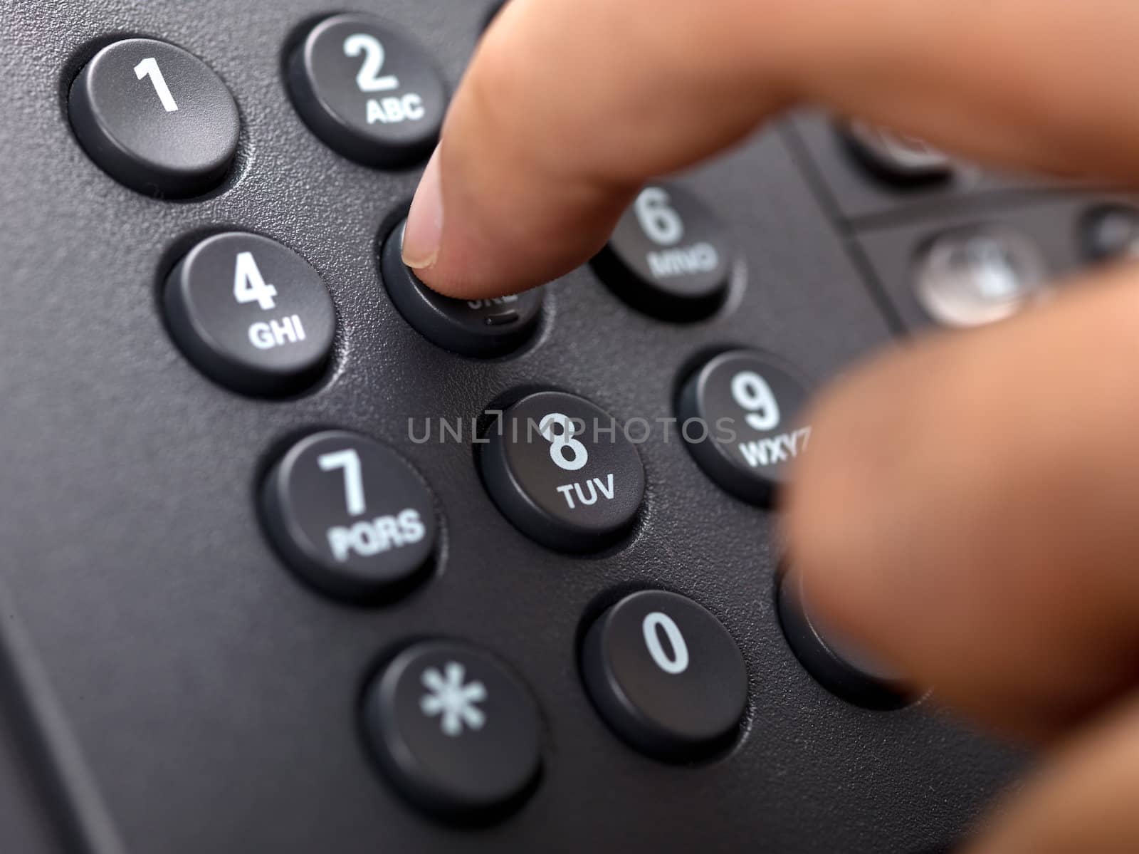 close up shot of human finger pressing landline phone number by kozzi