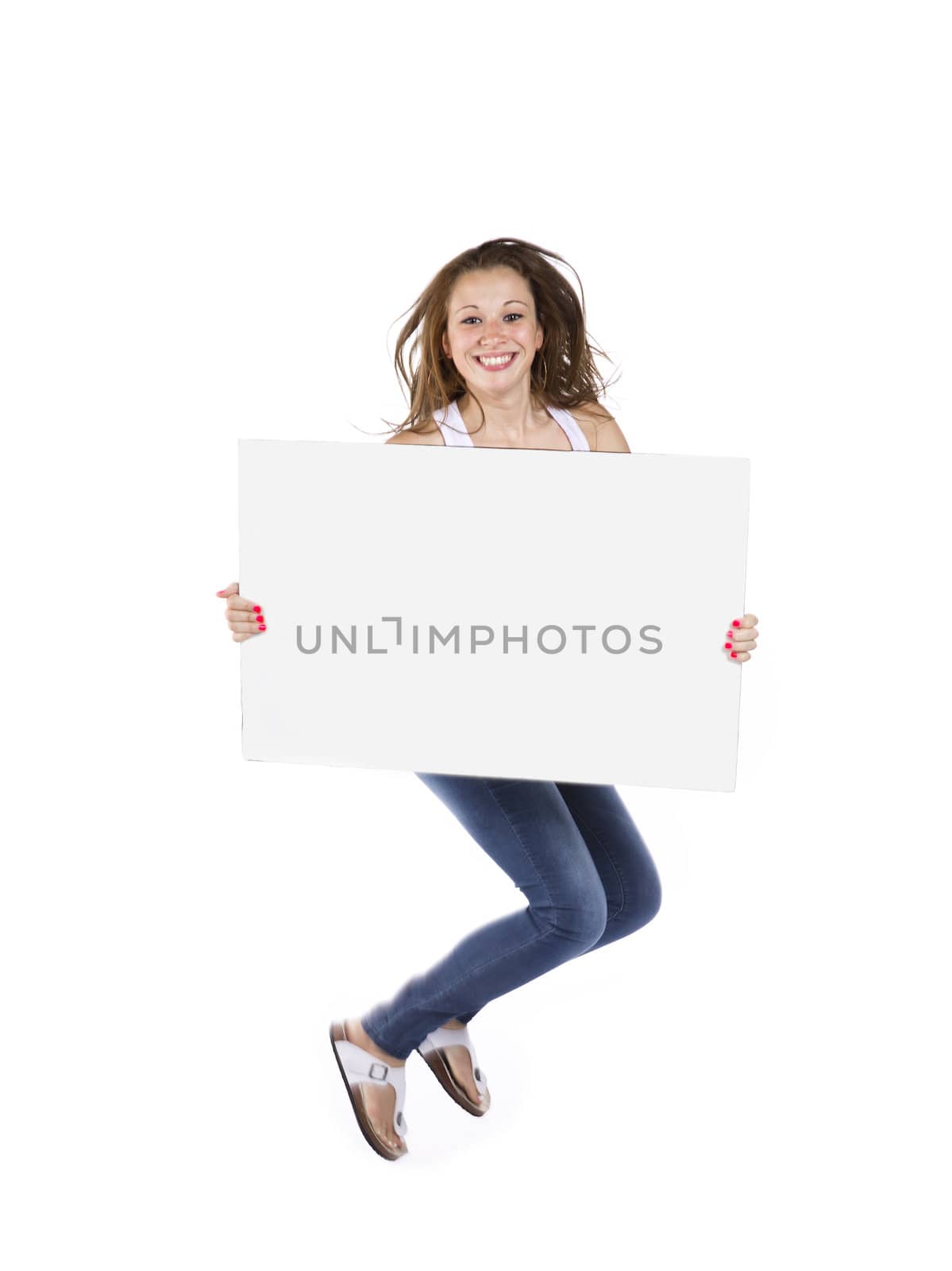 Portrait of a teenage girl jumping against white background with a placard.