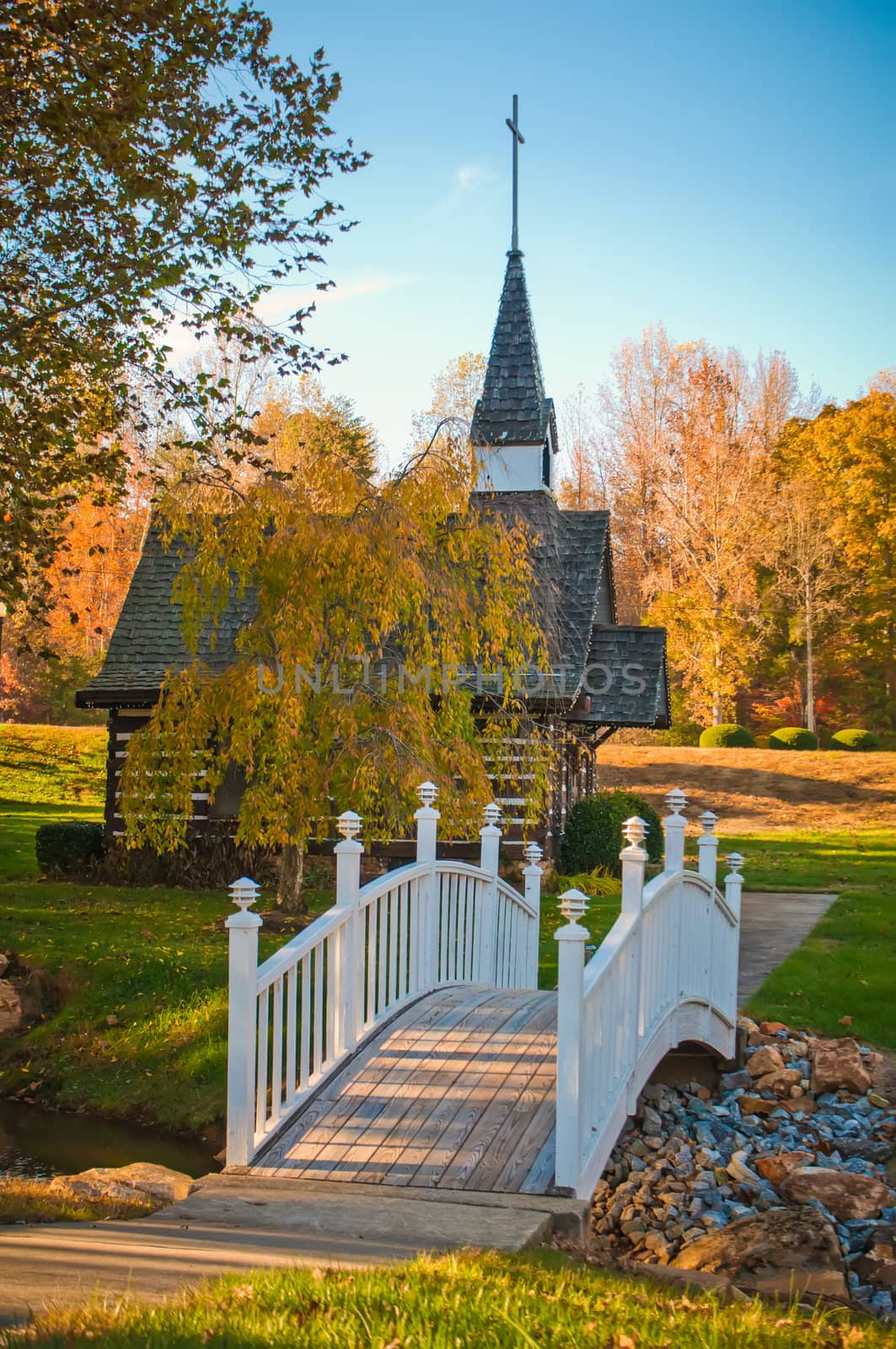 small chapel across the bridge in fall by digidreamgrafix