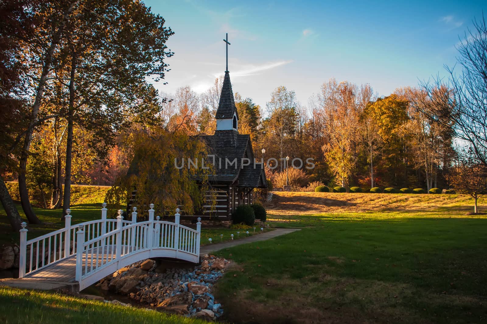 small chapel across the bridge in fall by digidreamgrafix