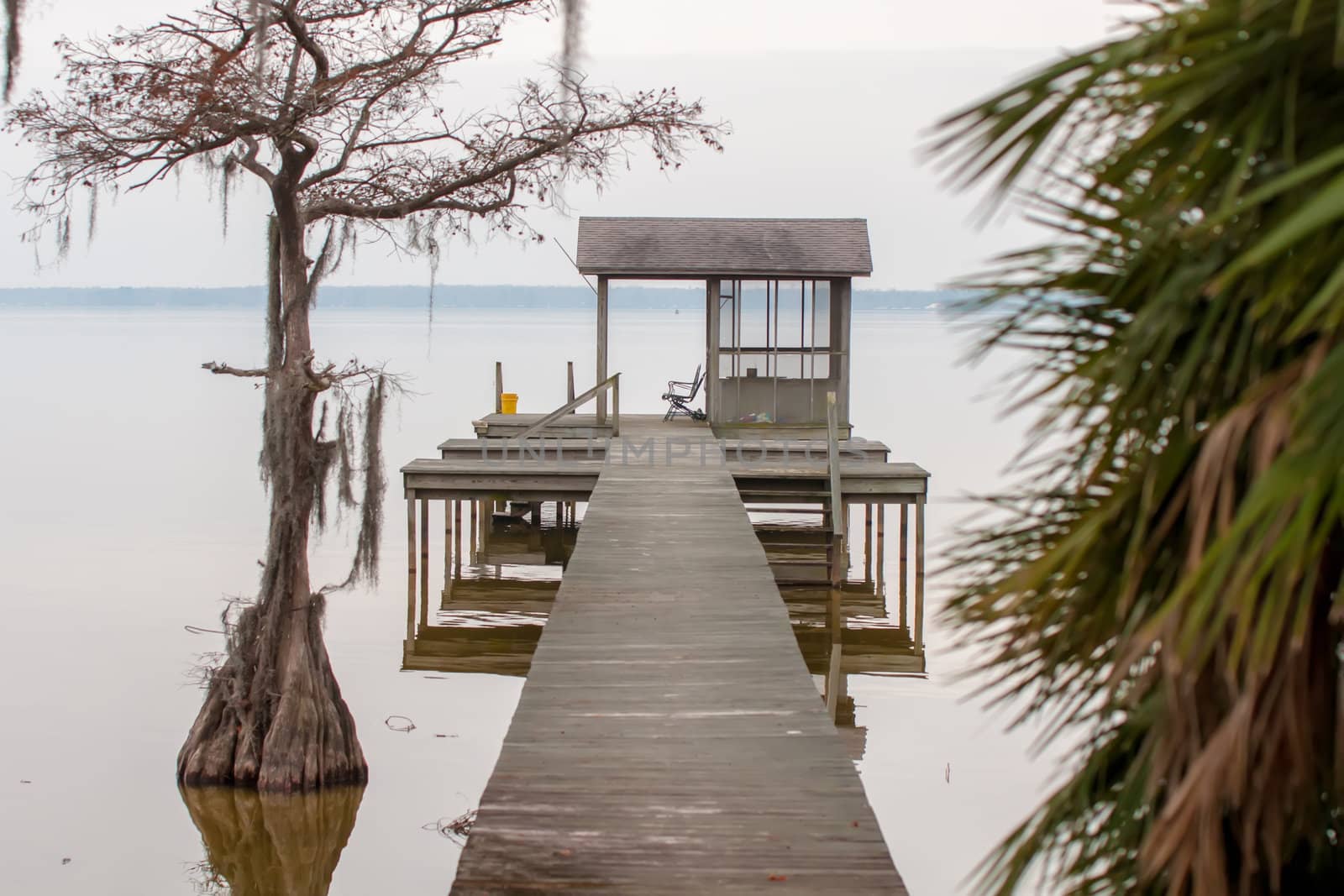 gazebo pier on a lake with chairs