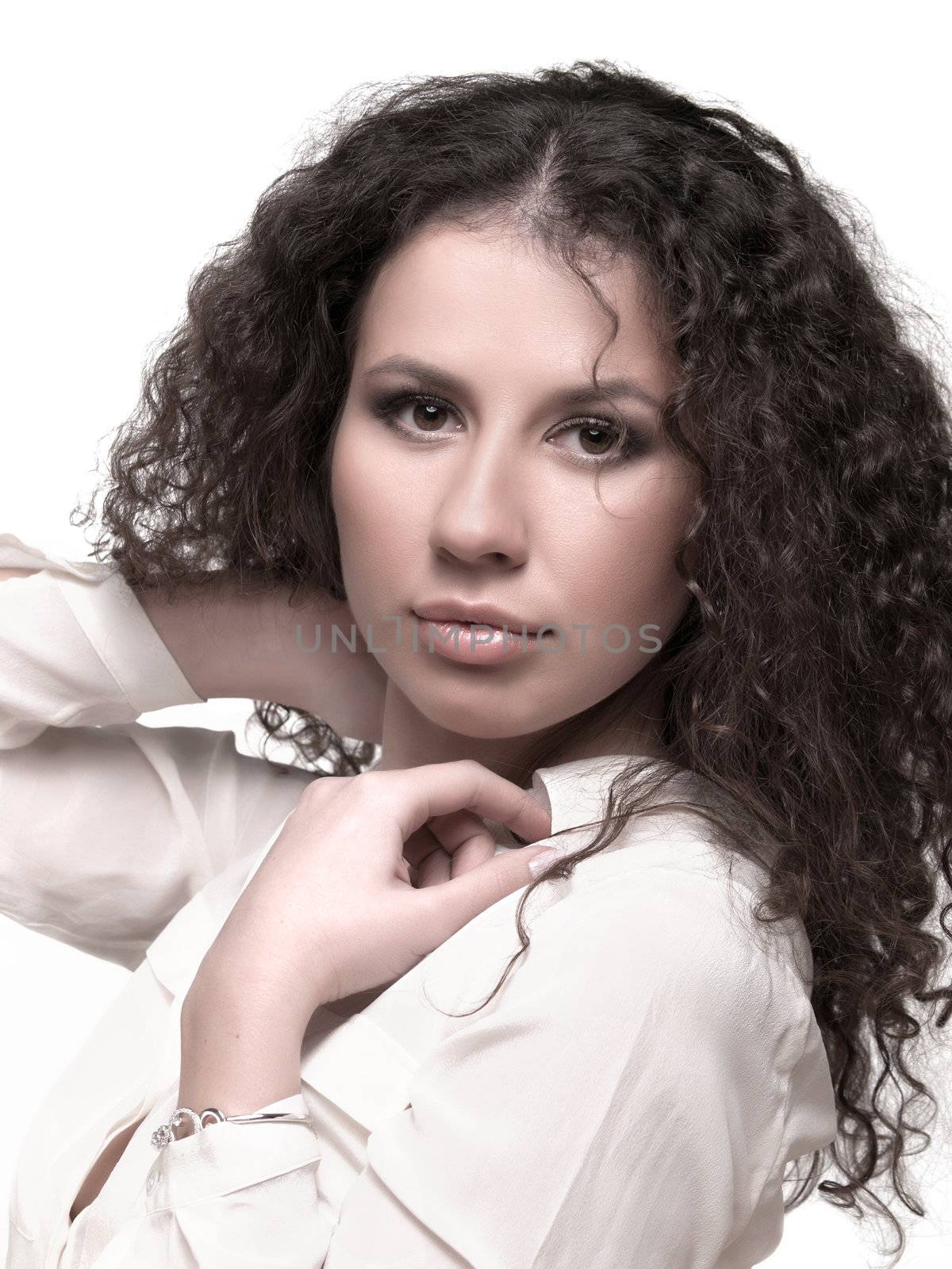 Beauty portrait of a young woman with long curly hair