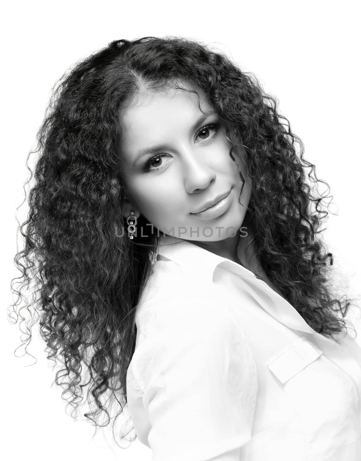 Black and white beauty portrait of a young woman with long curly hair