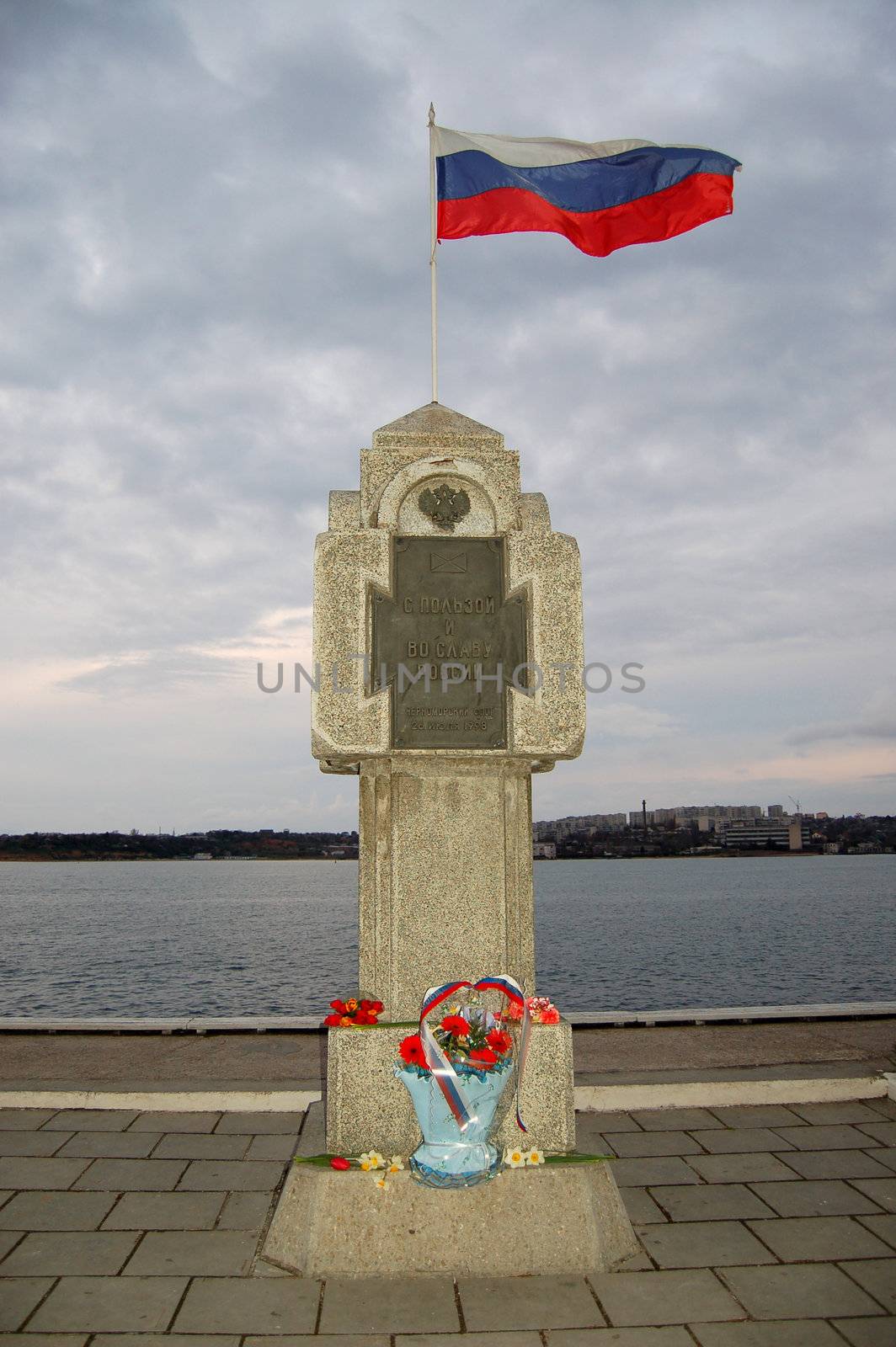 russian flag streaming in the wind over monument