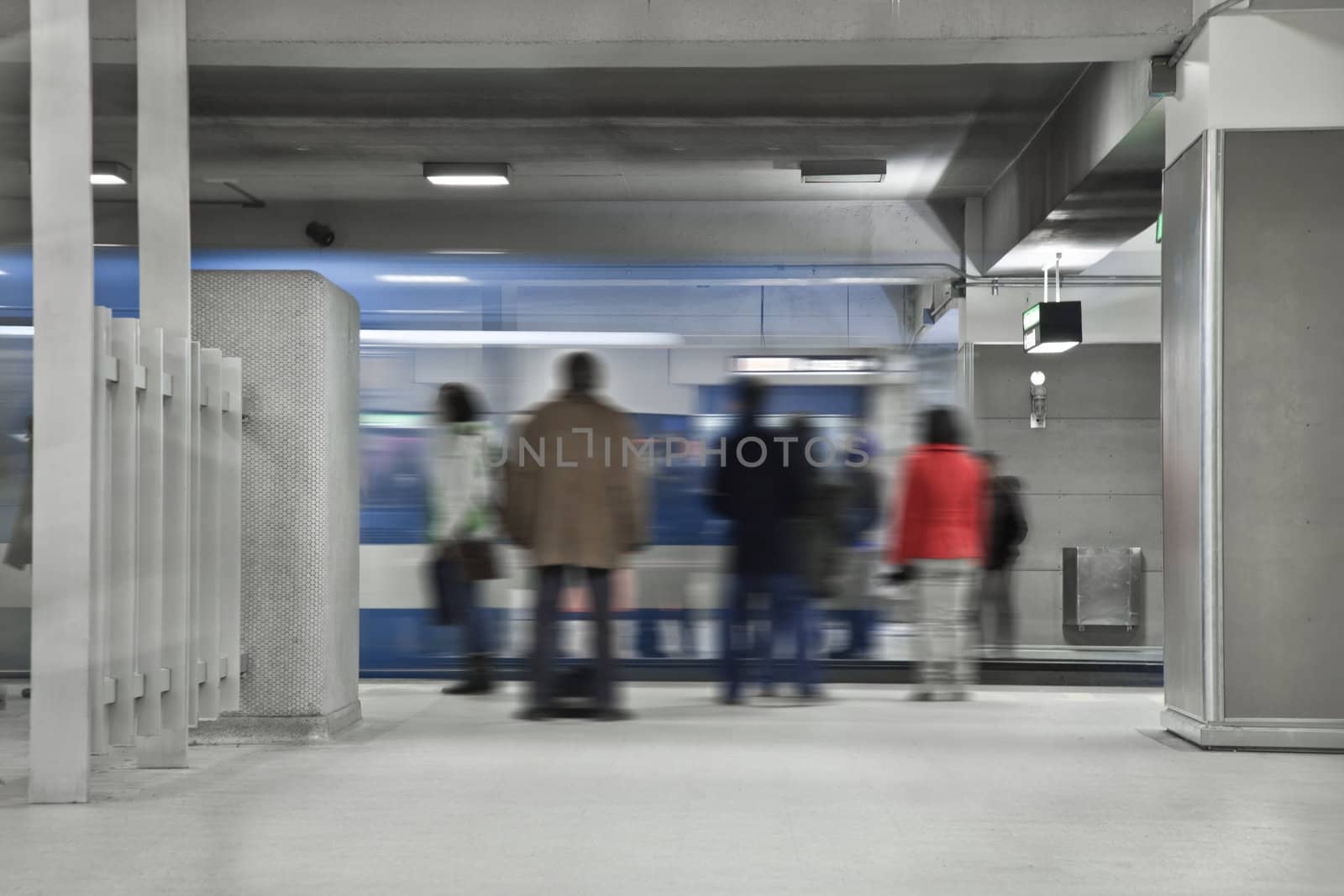 People waiting the next metro. A long exposure of the wagon that show the movements and a blurry people just standing there.Shot during the morning rush hour.