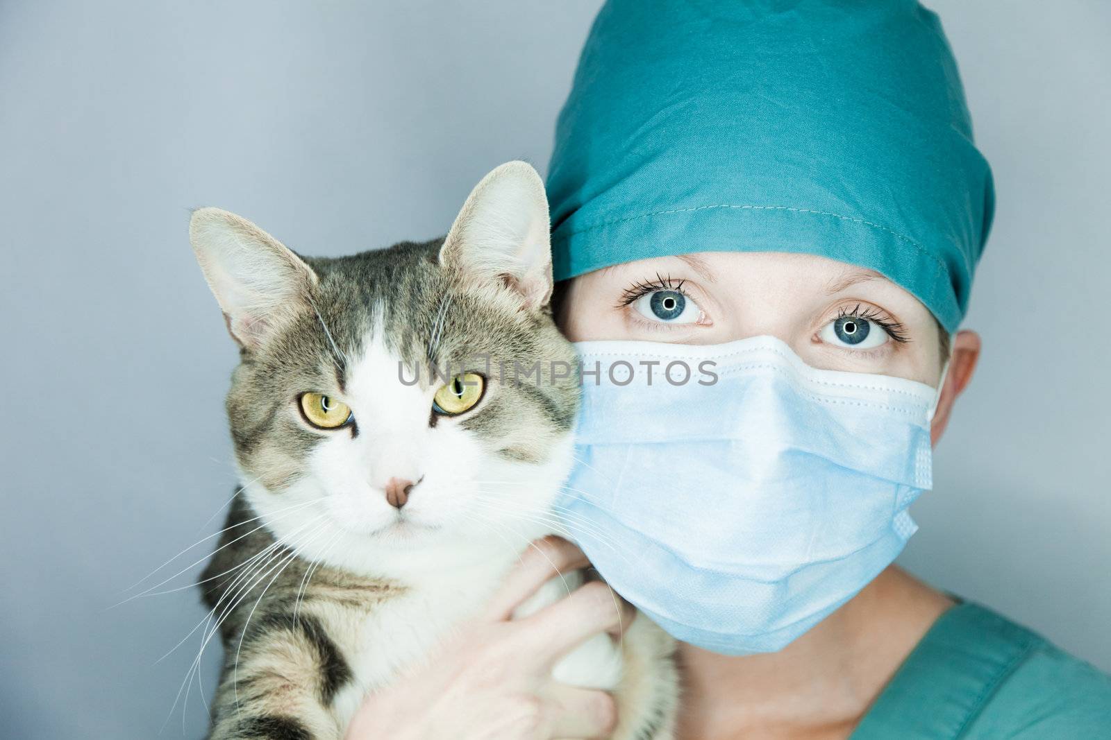 Young nurse in studio on a gray background