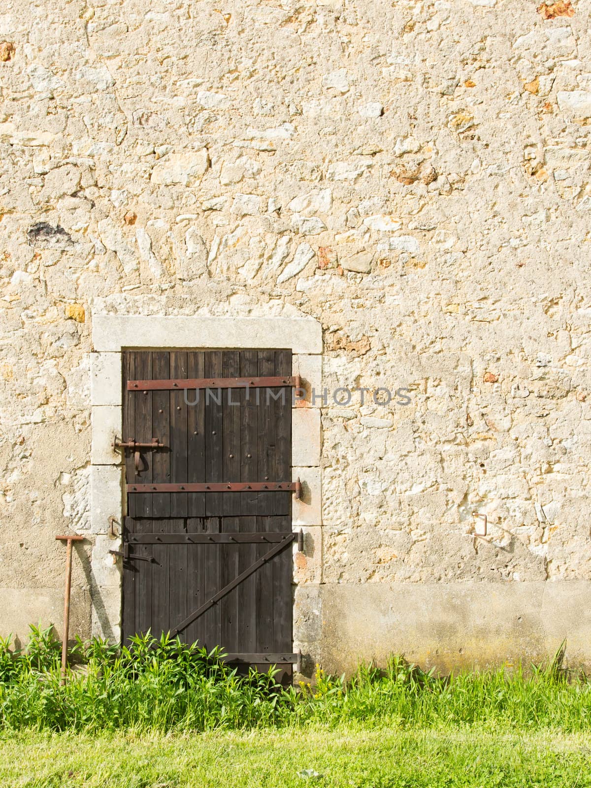 Old wooden door in an old stone wall