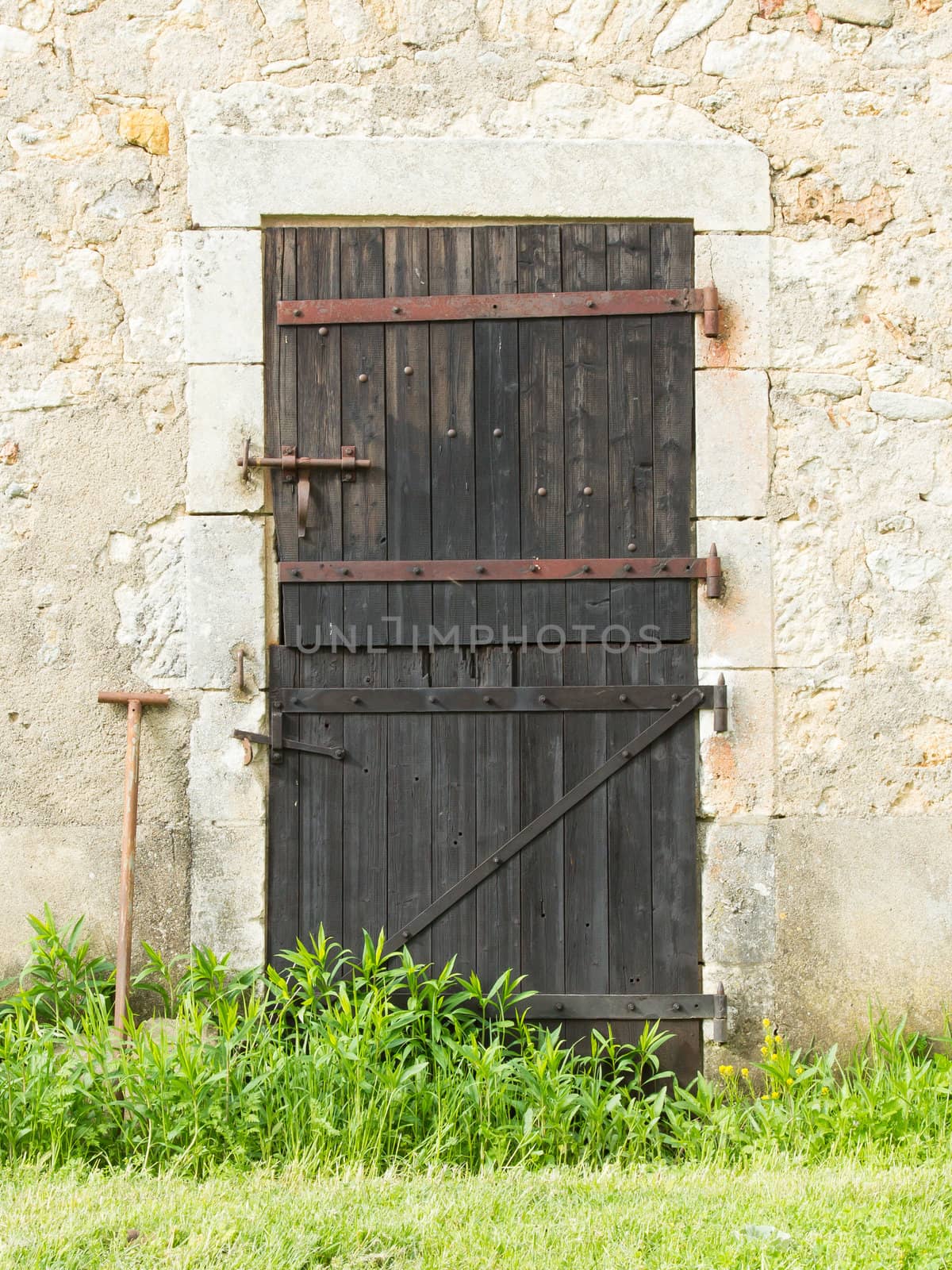 Old wooden door in an old stone wall