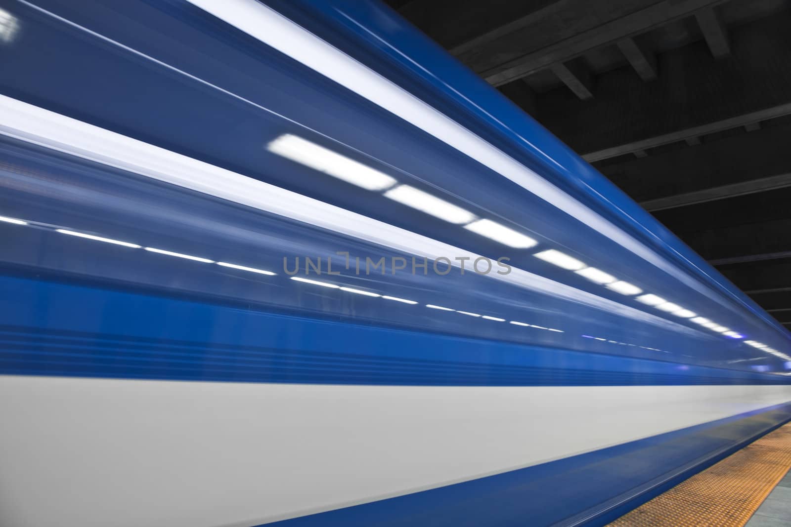 Just a close shot and almost abstract of a metro passing by. Long exposure and no people in the shot. This image create some nice white stripes !