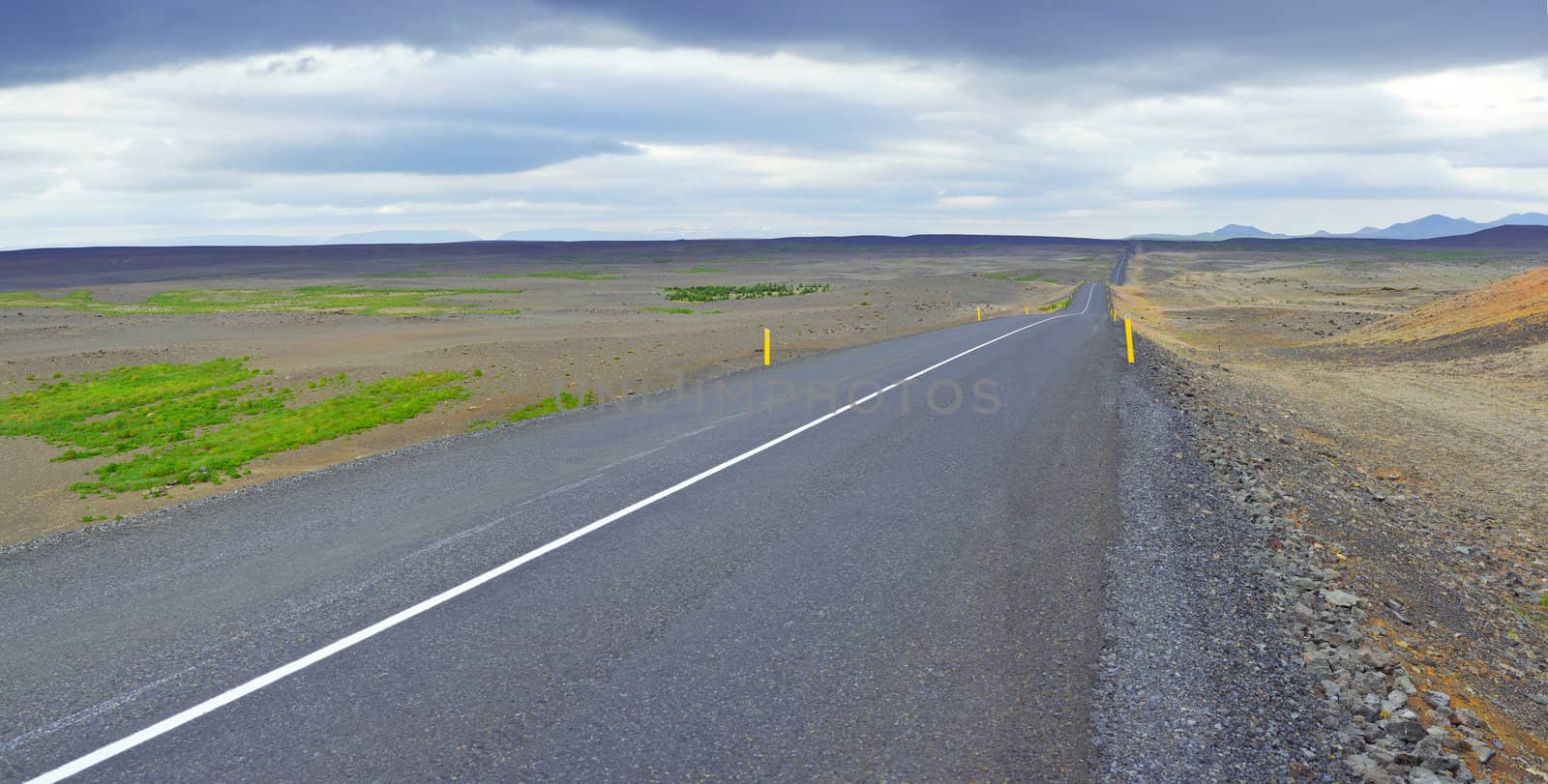 Highway through Iceland landscape at foggy day. Panorama