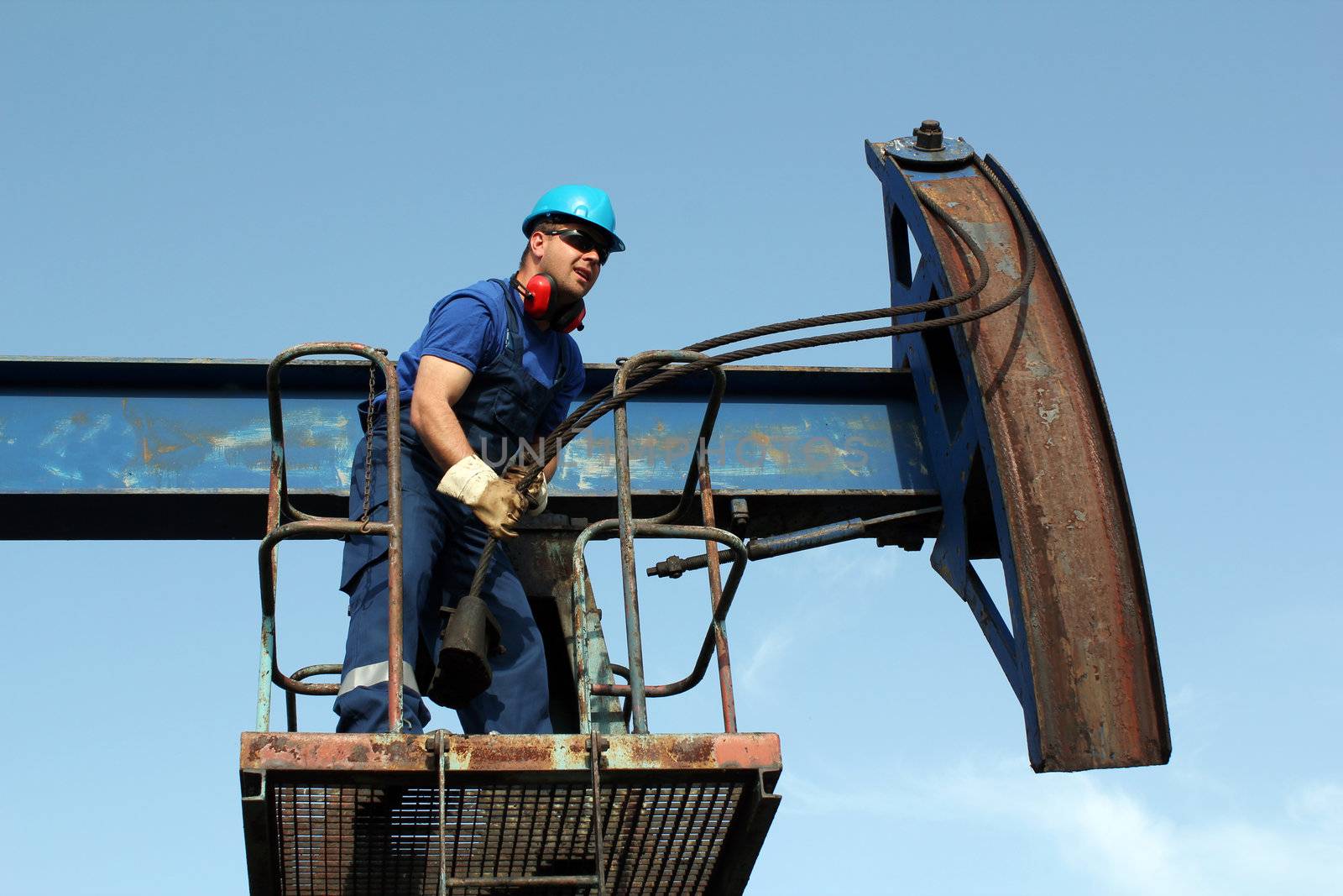 worker working in the oil field by goce