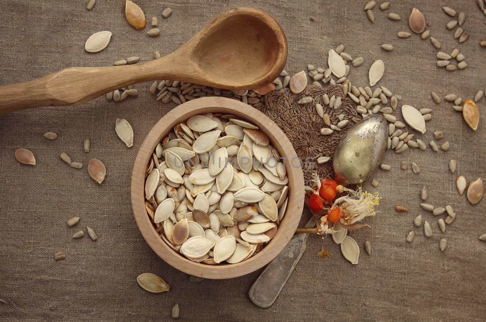 The pumpkin seeds and sunflower seeds and spoon by cococinema