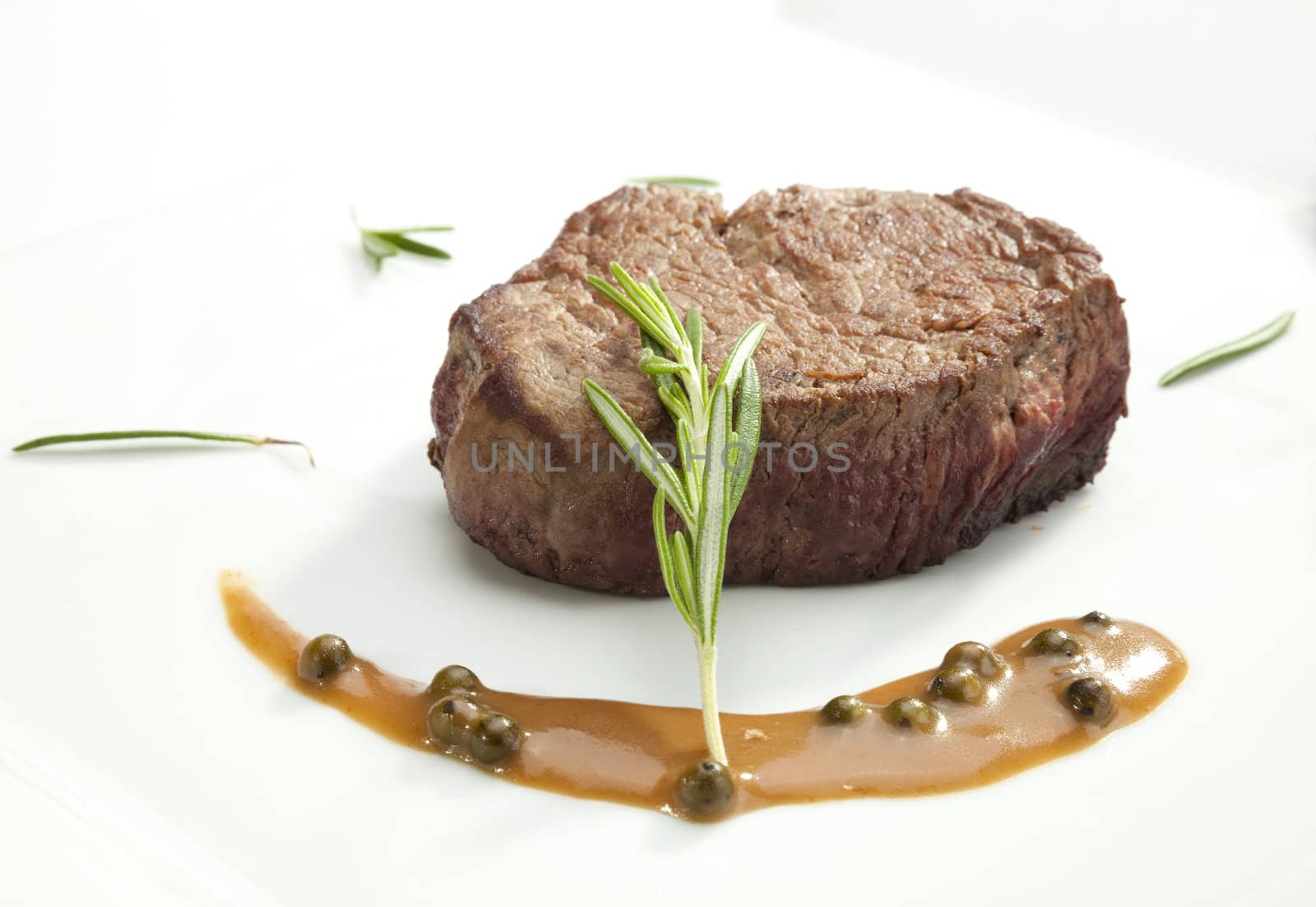 Beefsteak Tenderloin with the rosemary on the white plate