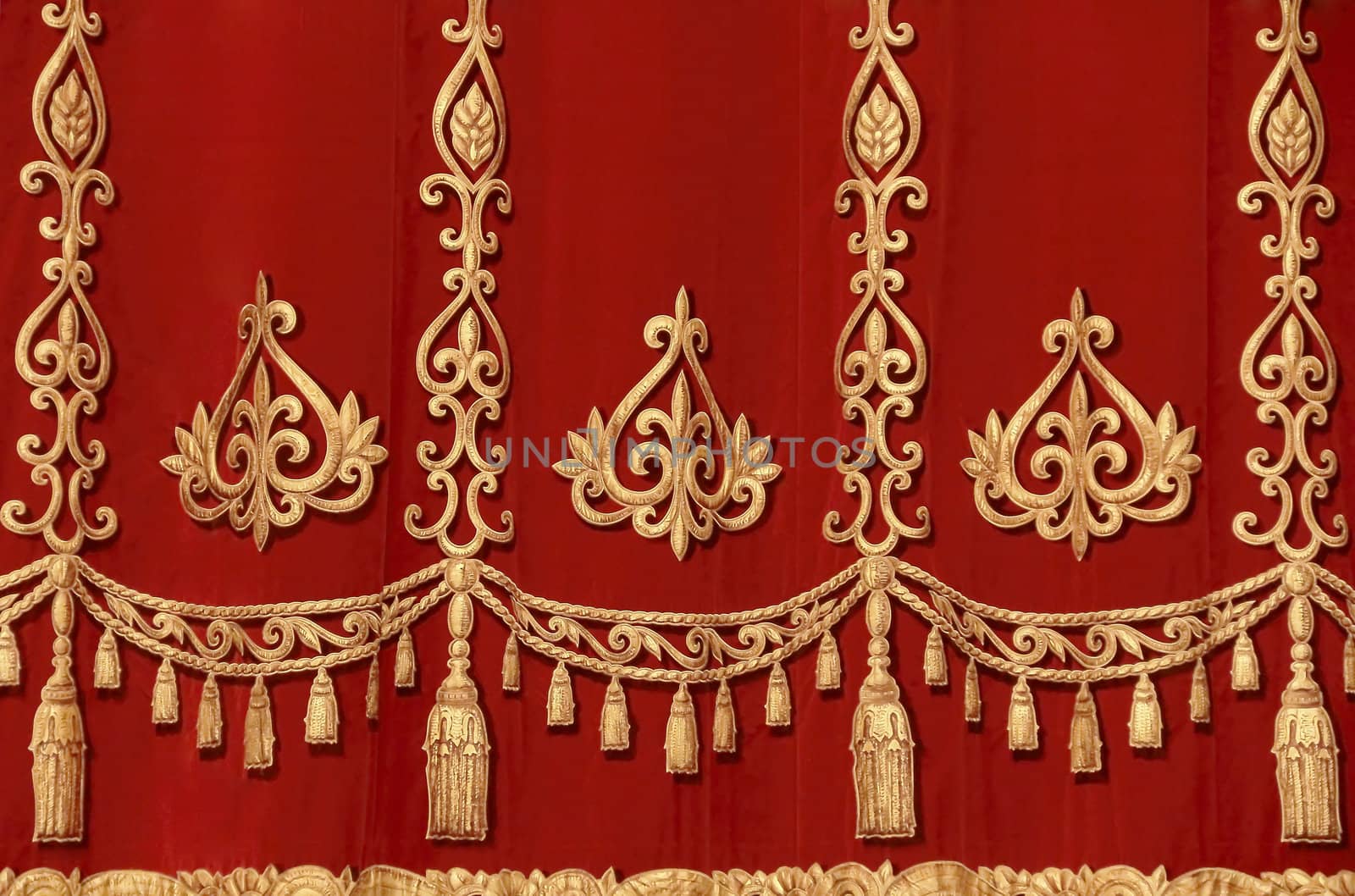 Theatrical red velvet curtain with gold pattern