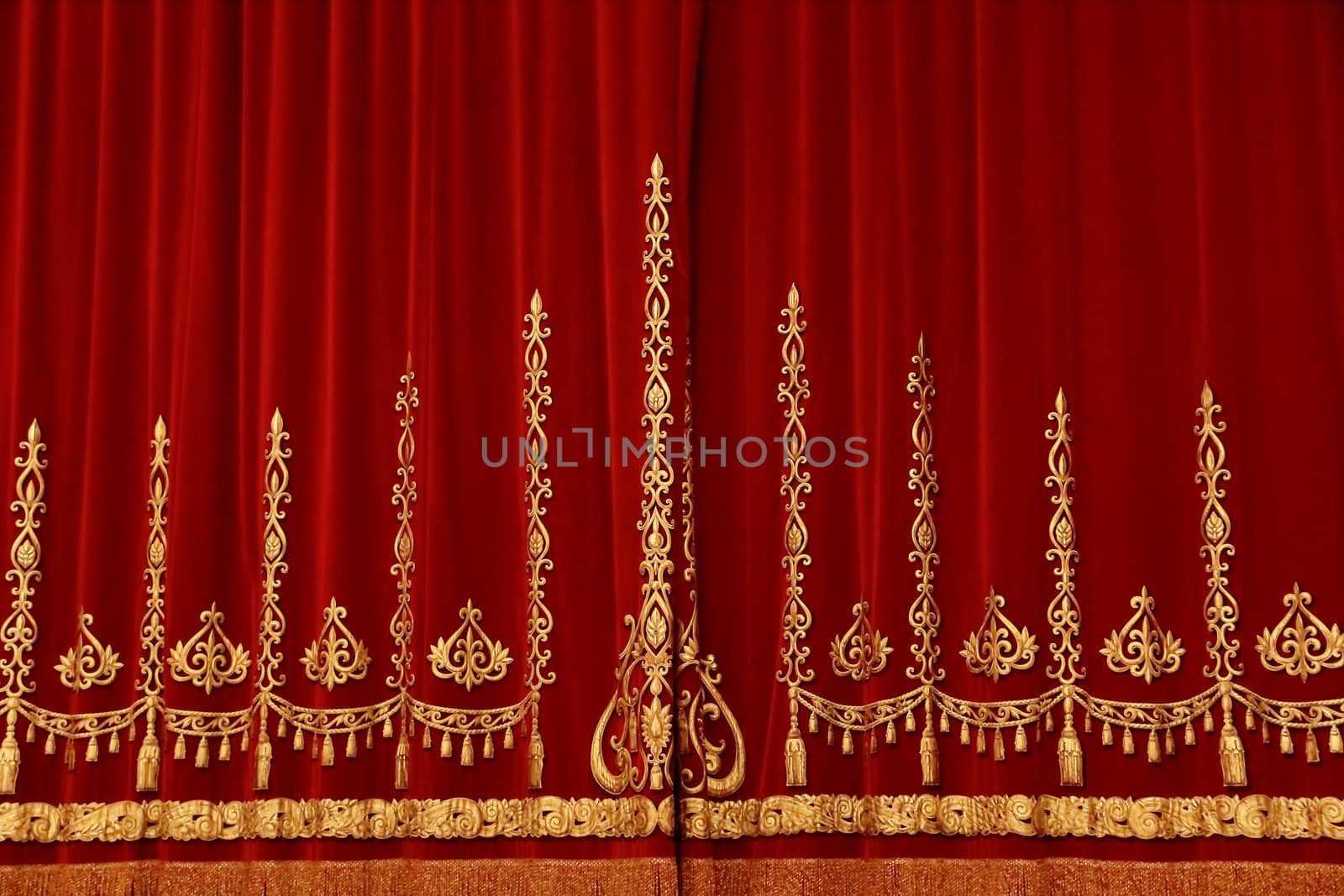 Theatrical red velvet curtain with gold pattern