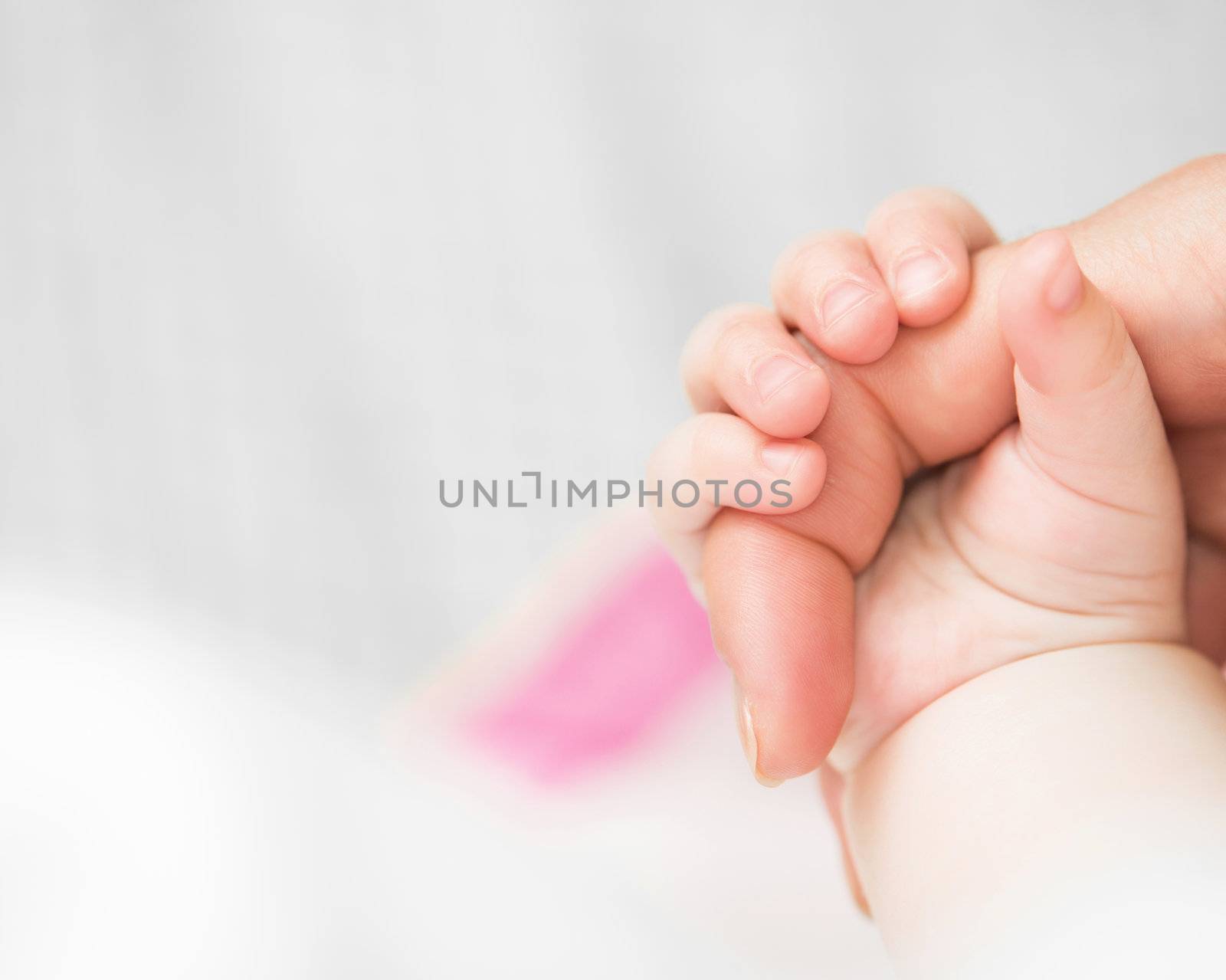 baby holds mother's finger by GekaSkr