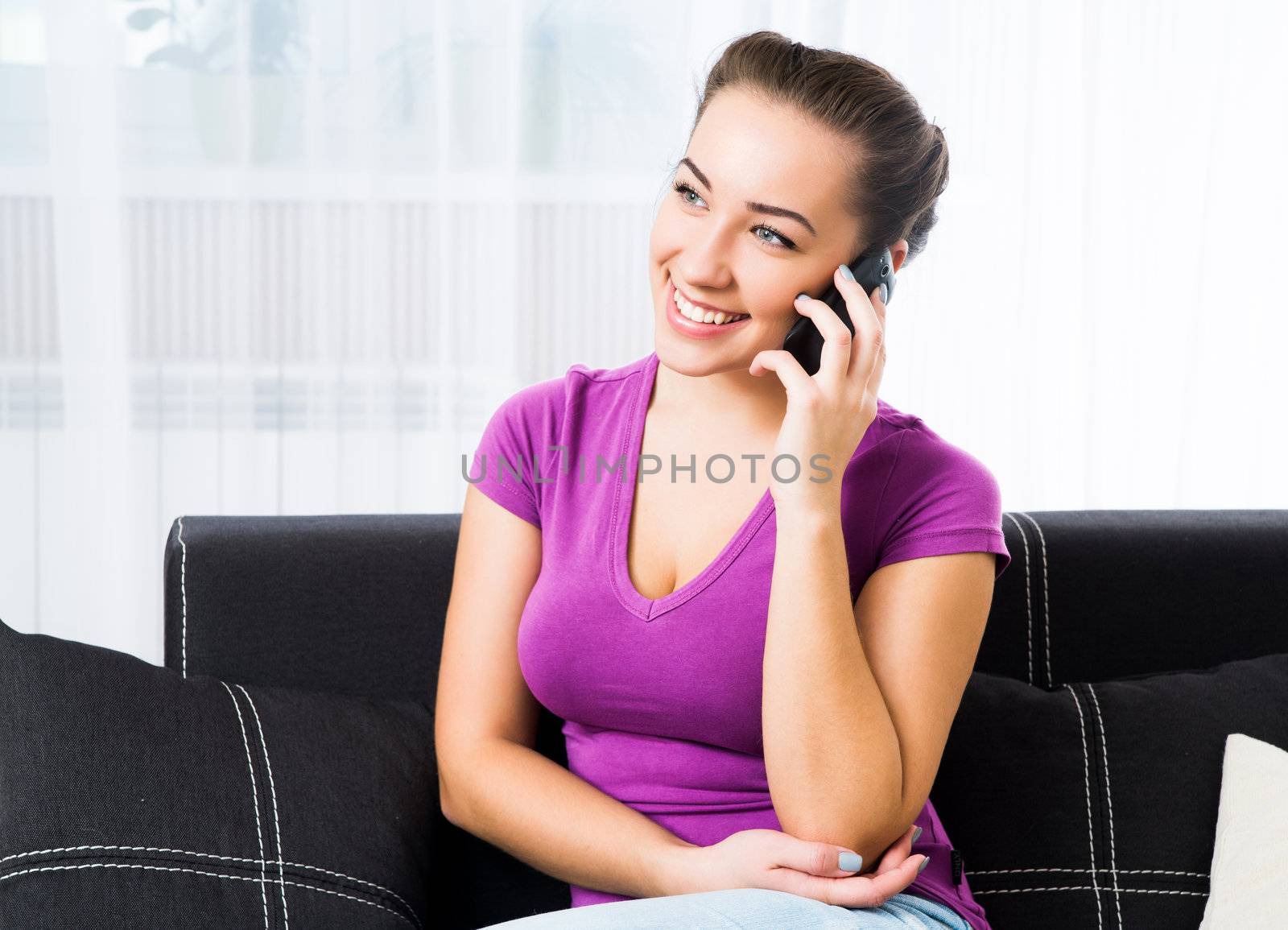 Attractive young brunette woman with her cell phone
