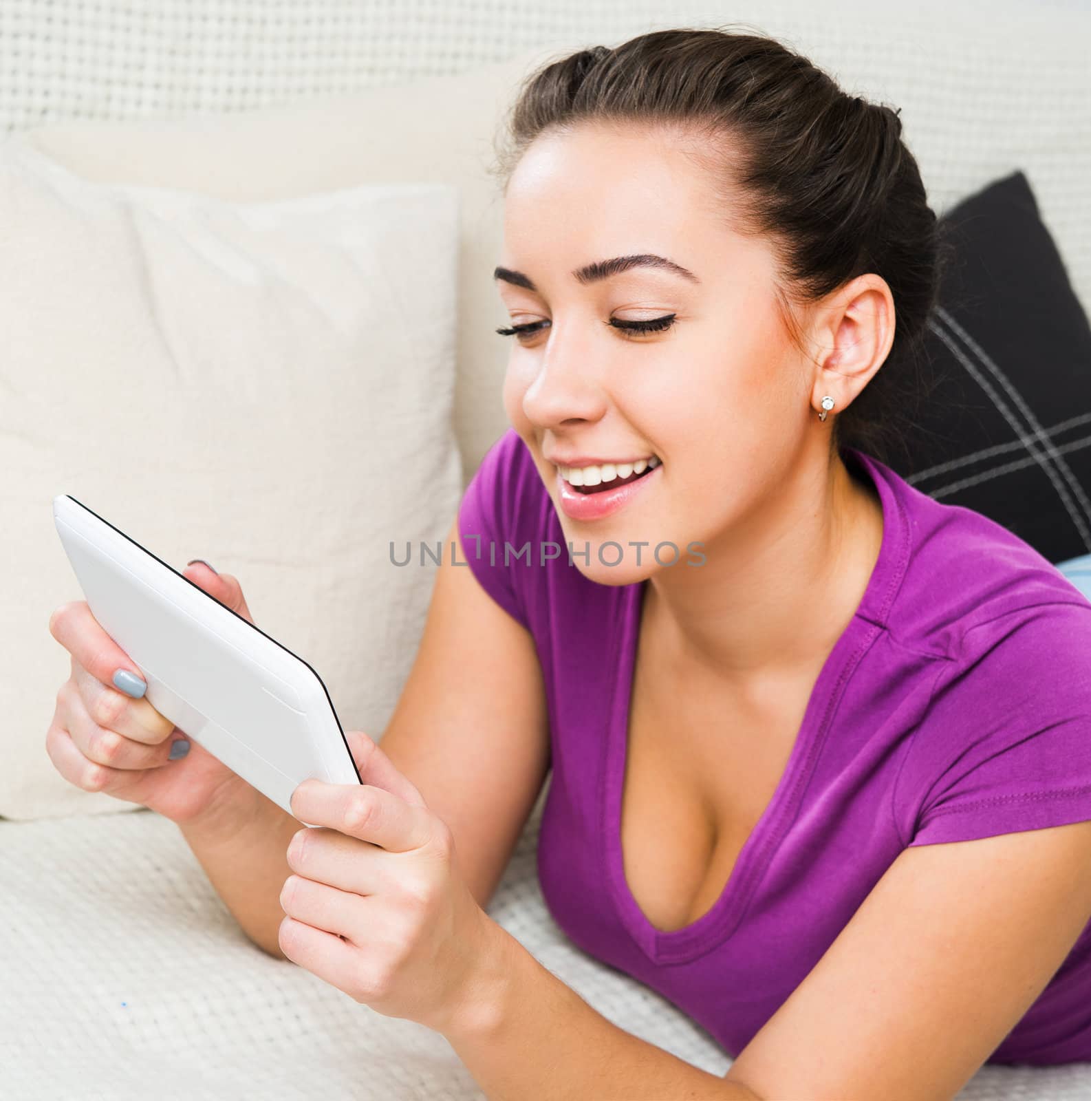 Smiling Brunette girl with white tablet pc