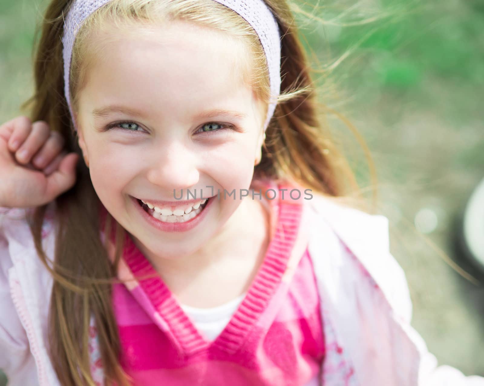 Close-up portrait of a cute liitle girl in park