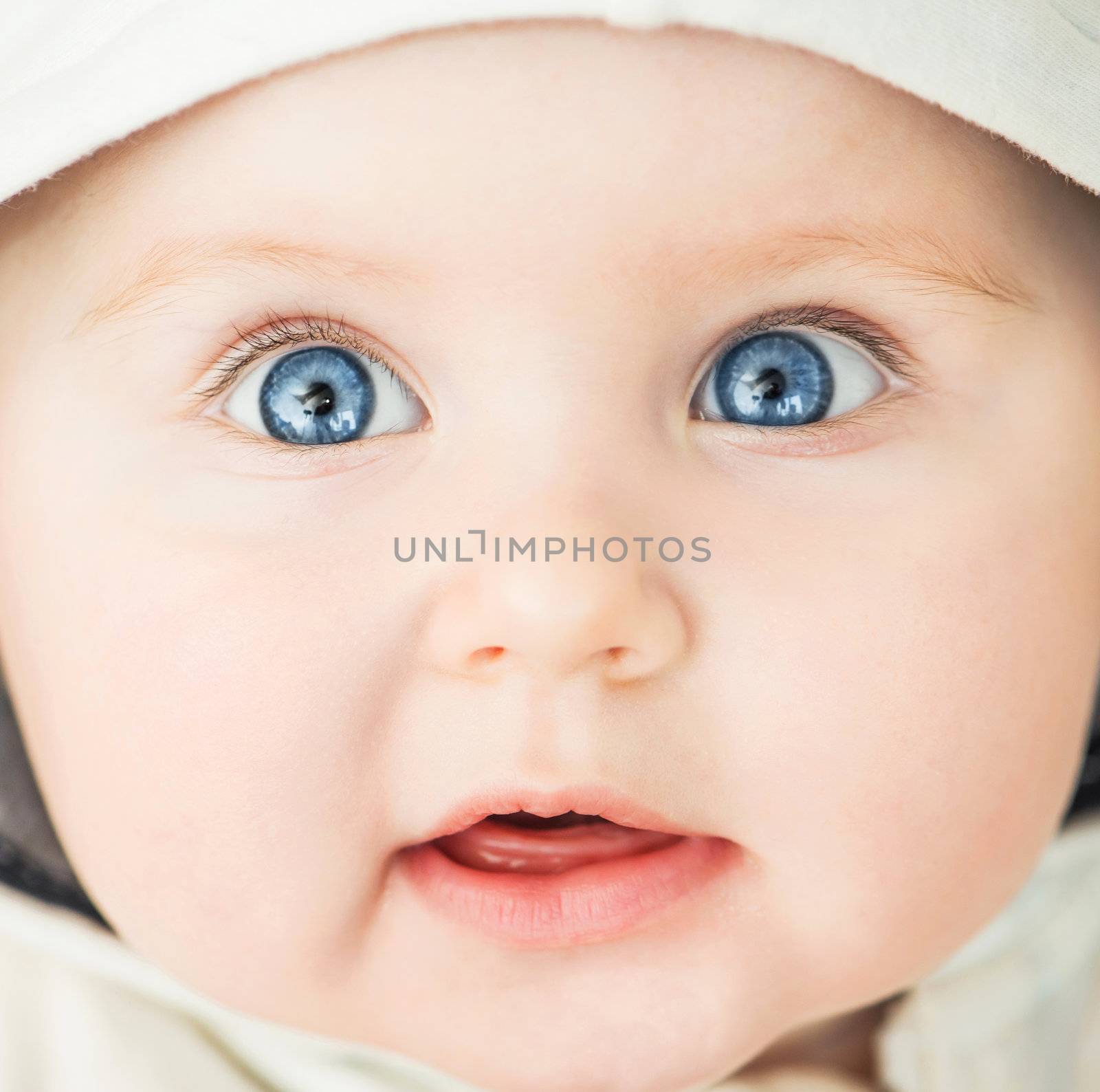 bright closeup portrait of cute baby in the hood