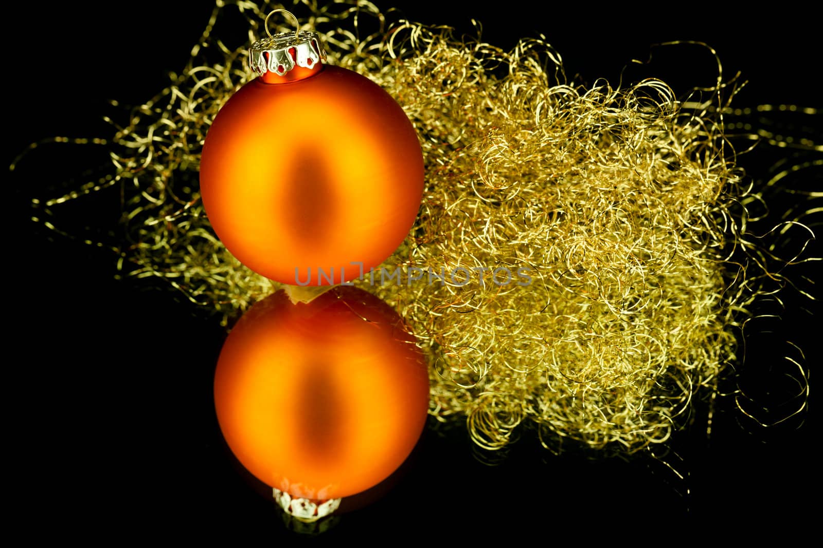 christmas decoration in orange and gold on black background