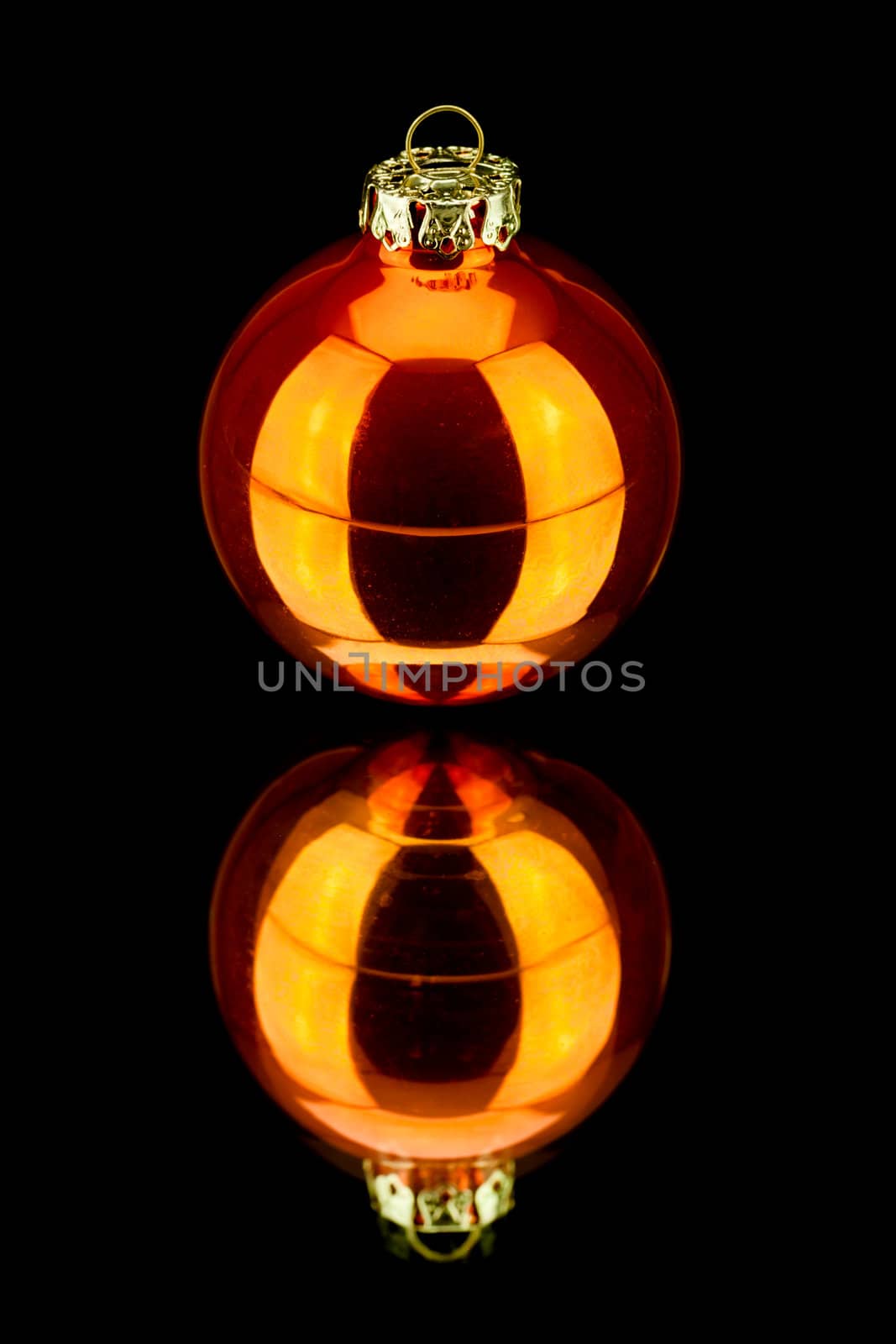 christmas decoration bauble in orange on black background