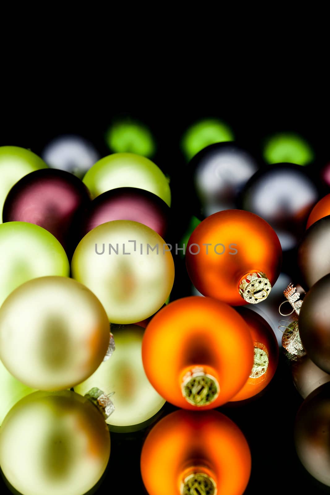 christmas decoration in gold lime green and mixed colours isolated on black background