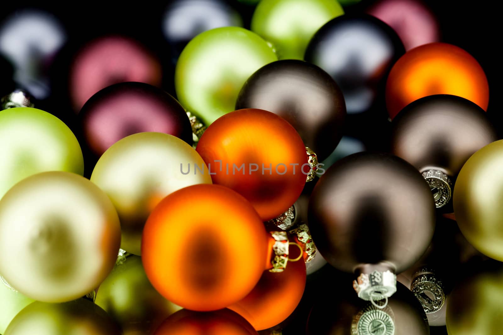christmas decoration in gold lime green and mixed colours isolated on black background