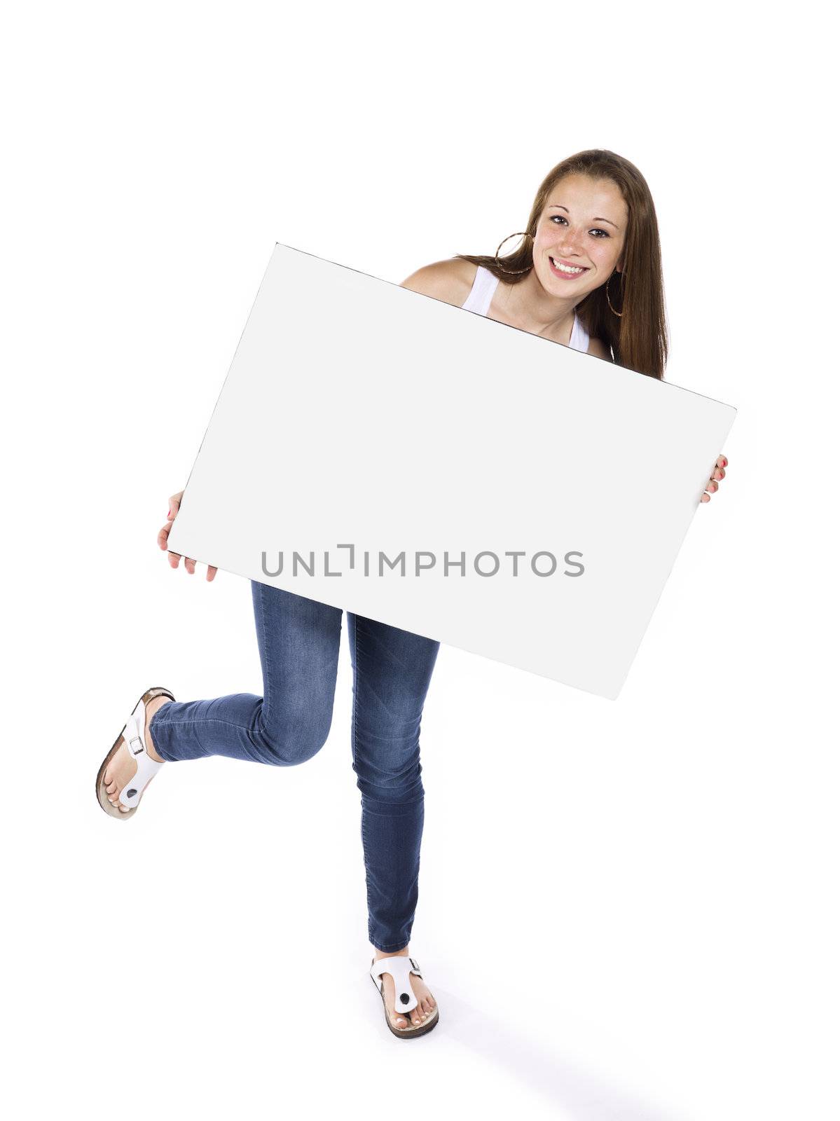 Cute teenage girl standing on one leg with a billboard against white background.