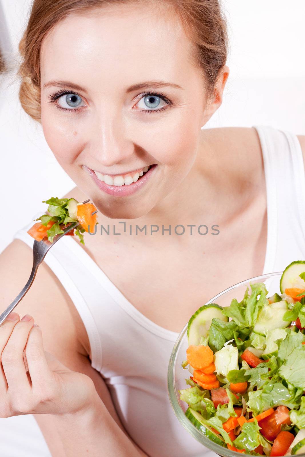 attractive young woman eating fresh healthy salad for lunch